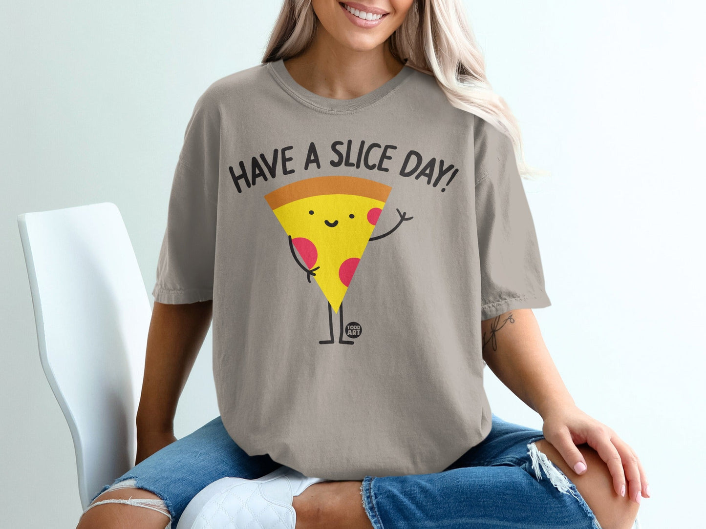 T-shirt with cartoon pizza slice saying "Have a Slice Day!".