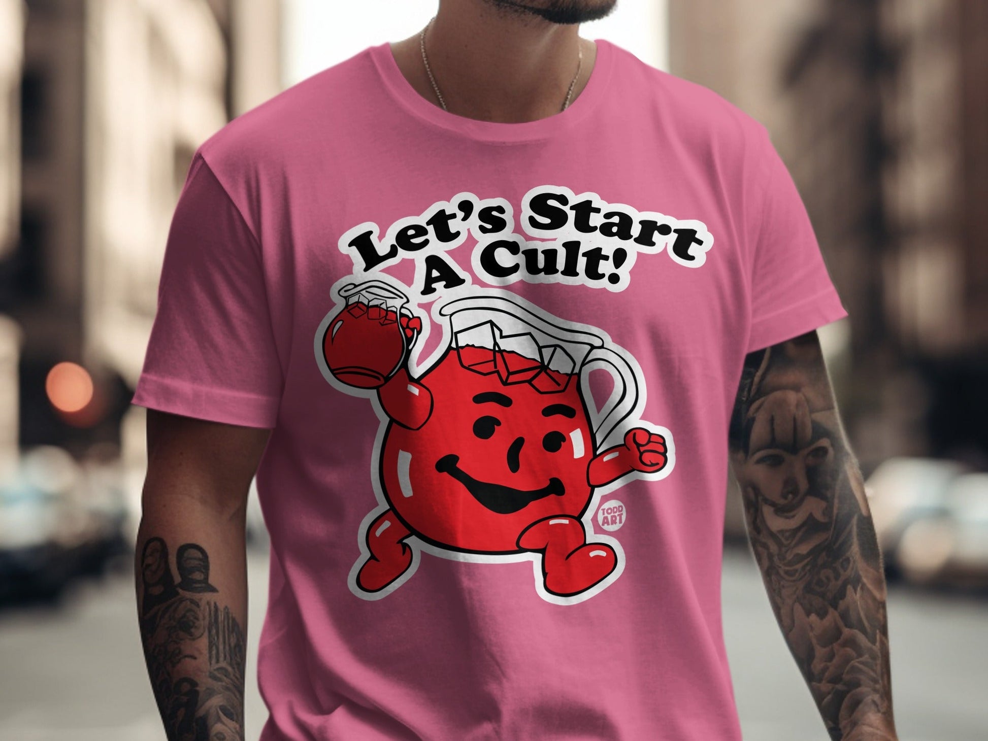 Kool-Aid man on pink t-shirt with "Let's Start a Cult!" text.