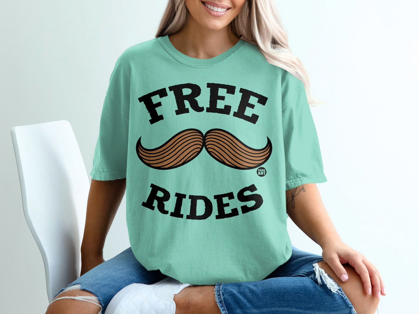 Teal t-shirt with "FREE RIDES" and a mustache graphic.