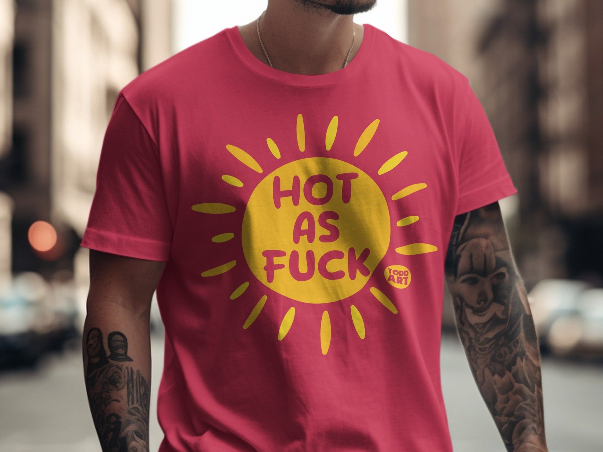 Pink t-shirt with yellow sun graphic and text "HOT AS FUCK".