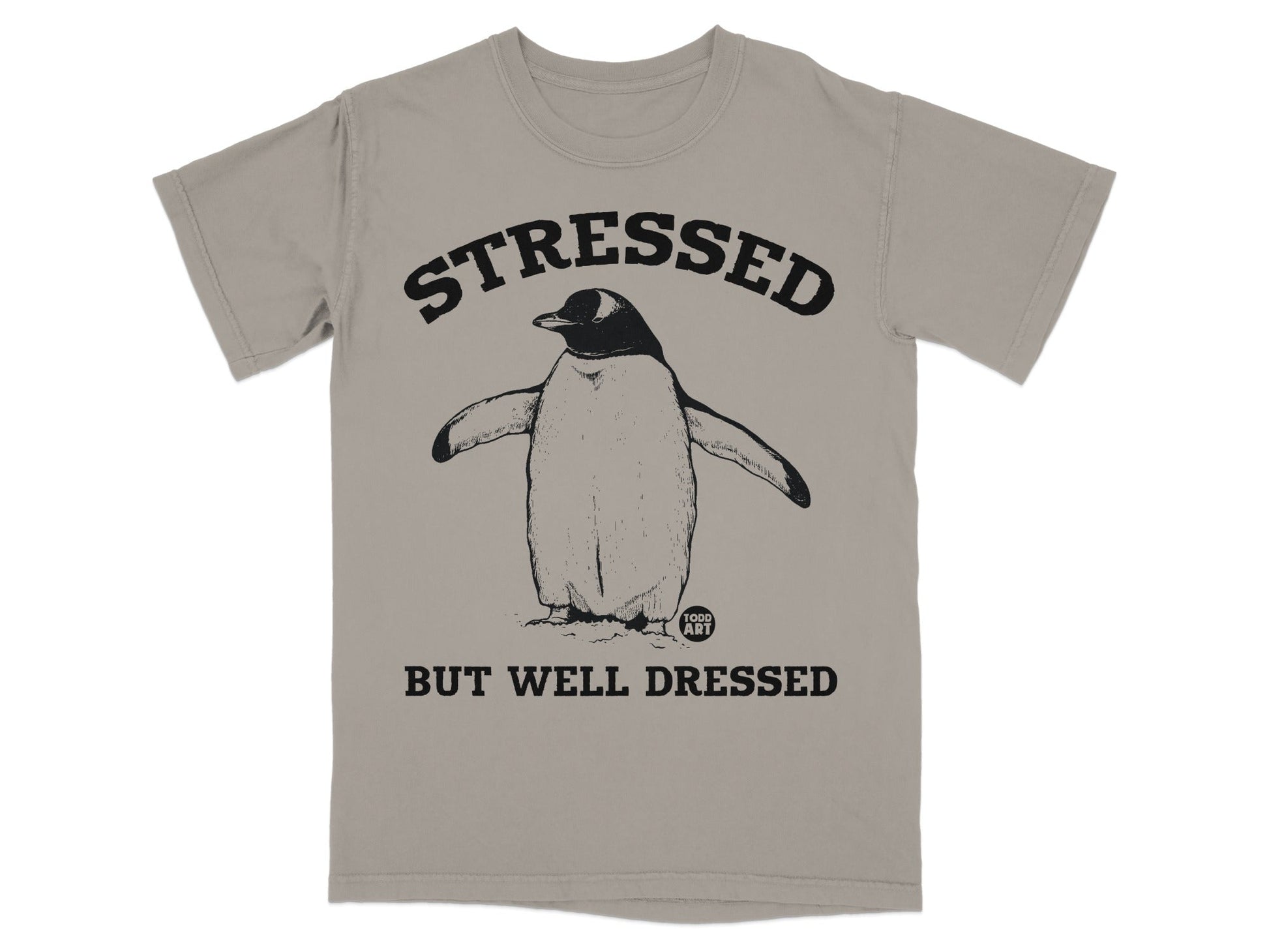 T-shirt with penguin graphic and text "STRESSED BUT WELL DRESSED."