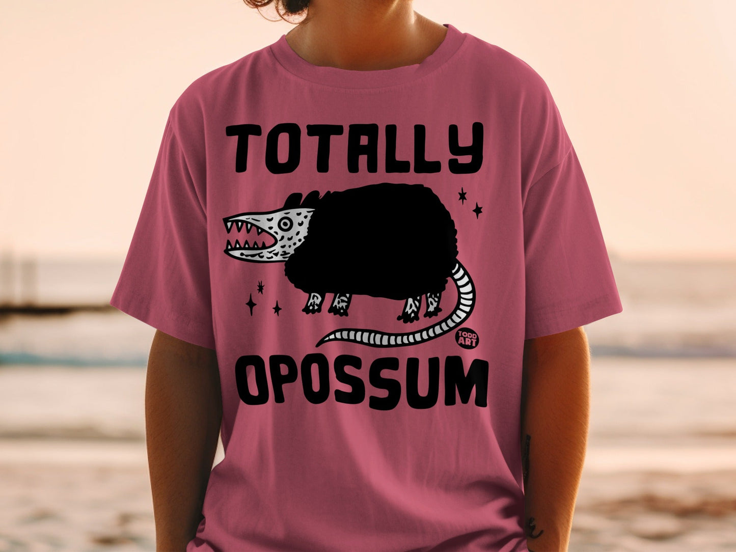 T-shirt with "Totally Opossum" text and a cartoon opossum graphic.