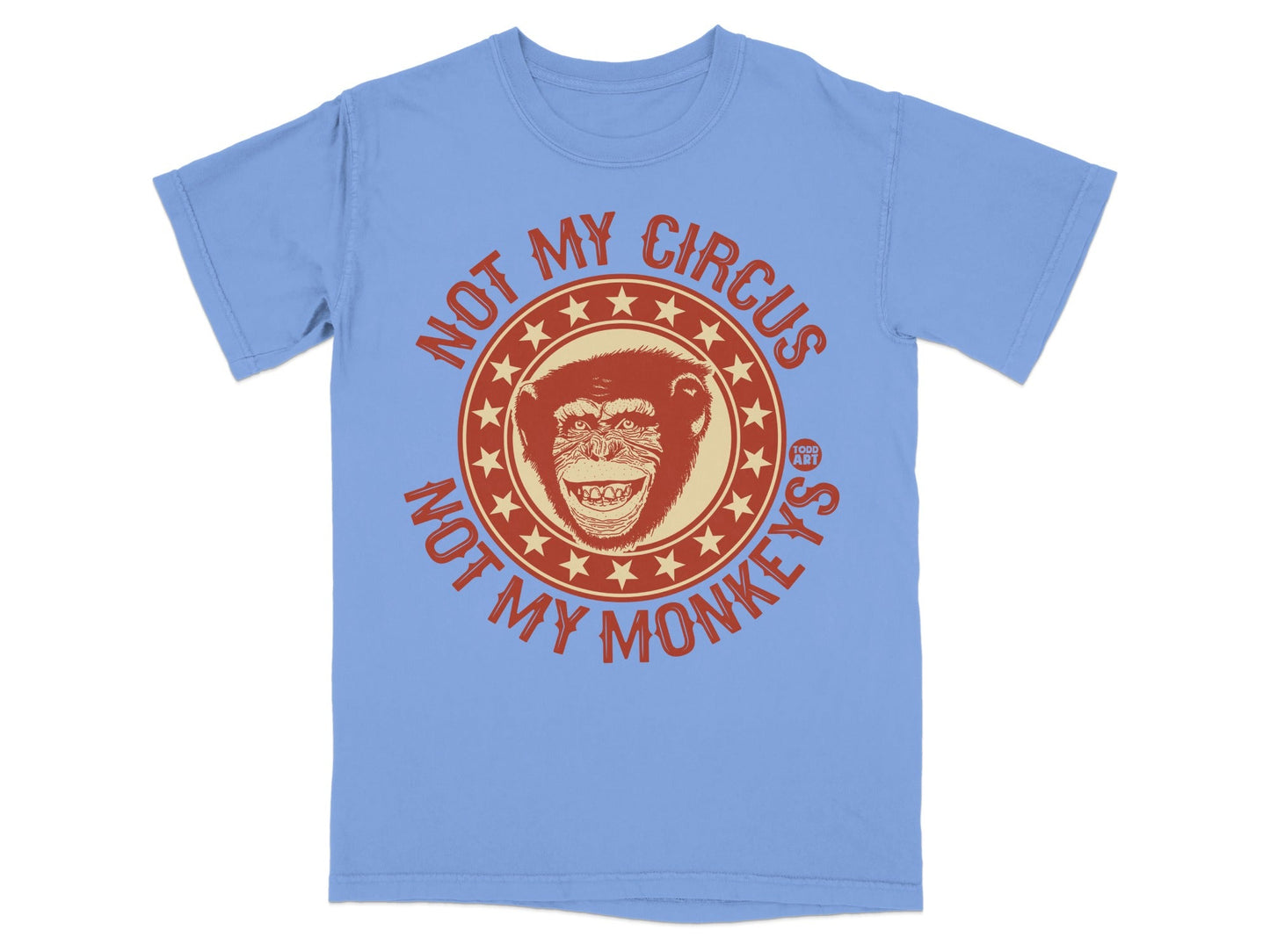 Light blue t-shirt with a distressed circle graphic featuring a monkey and "NOT MY CIRCUS NOT MY MONKEYS" text.