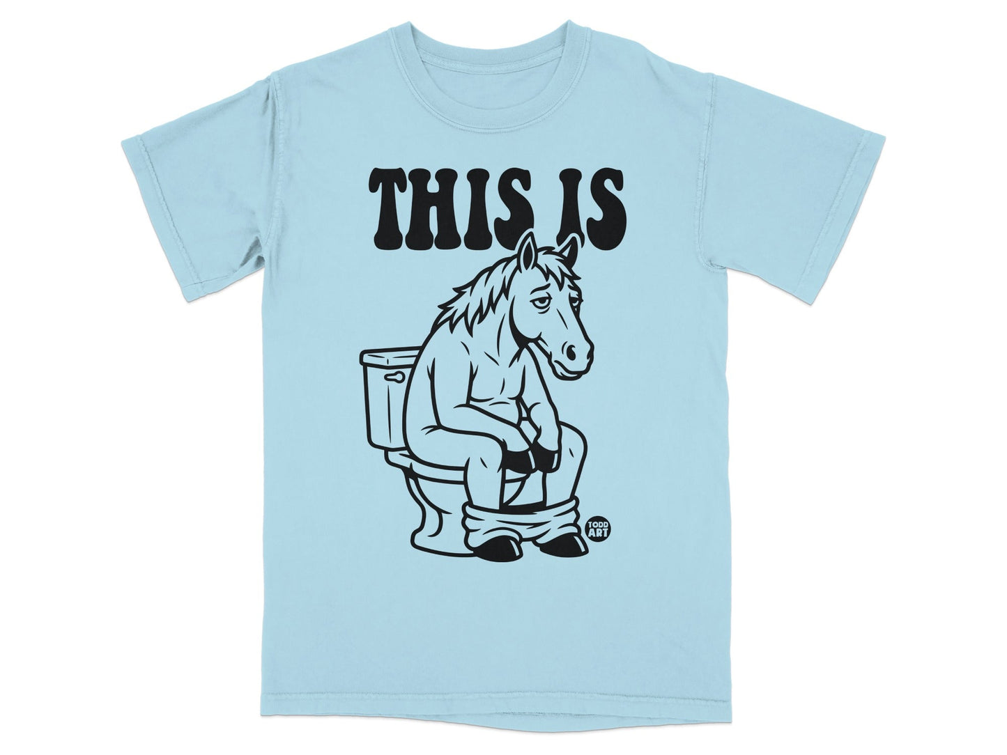 Light blue t-shirt with "THIS IS" and a horse sitting on a toilet.