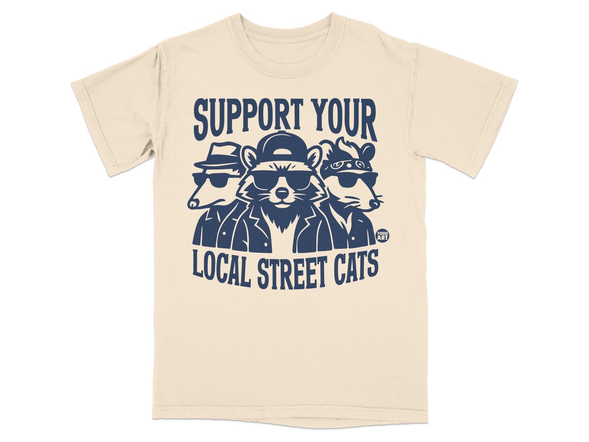 T-shirt with three cartoon raccoons wearing hats and sunglasses, text reads "SUPPORT YOUR LOCAL STREET CATS".
