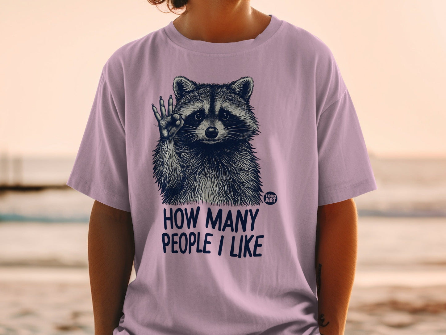 Purple t-shirt with raccoon giving a thumbs up and text "HOW MANY PEOPLE I LIKE".