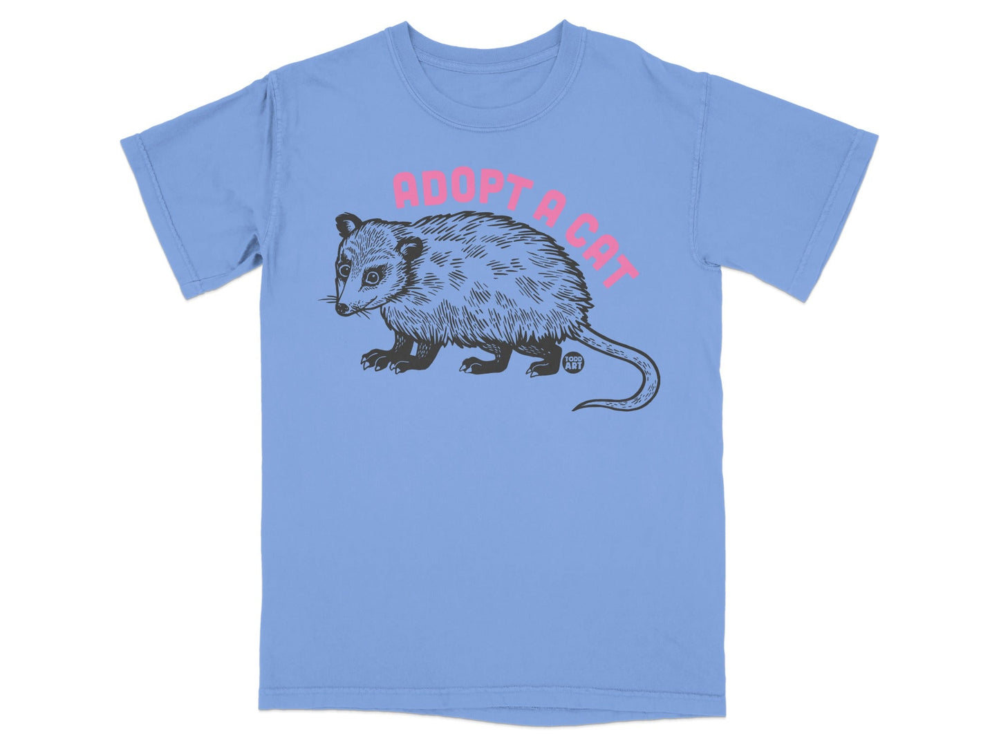 Light blue t-shirt with pink "Adopt a Cat" text and black opossum illustration.