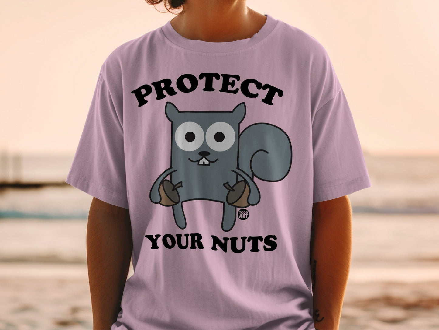 T-shirt with a cartoon squirrel holding acorns and the text "Protect Your Nuts".