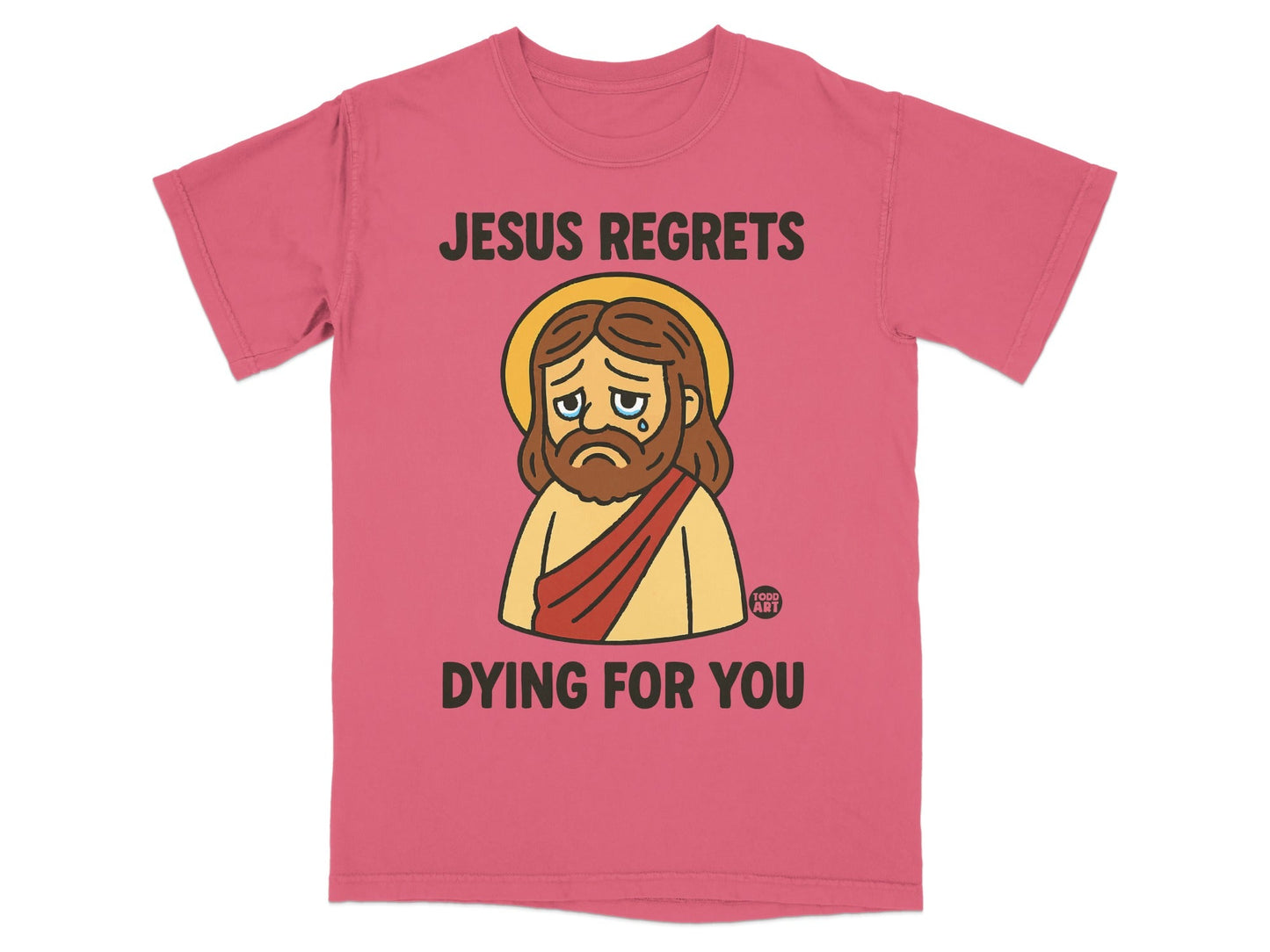 Pink t-shirt with sad cartoon Jesus and text "JESUS REGRETS DYING FOR YOU".