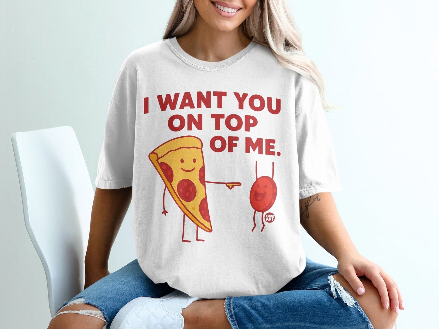 T-shirt with cartoon pizza slice saying "I want you on top of me."