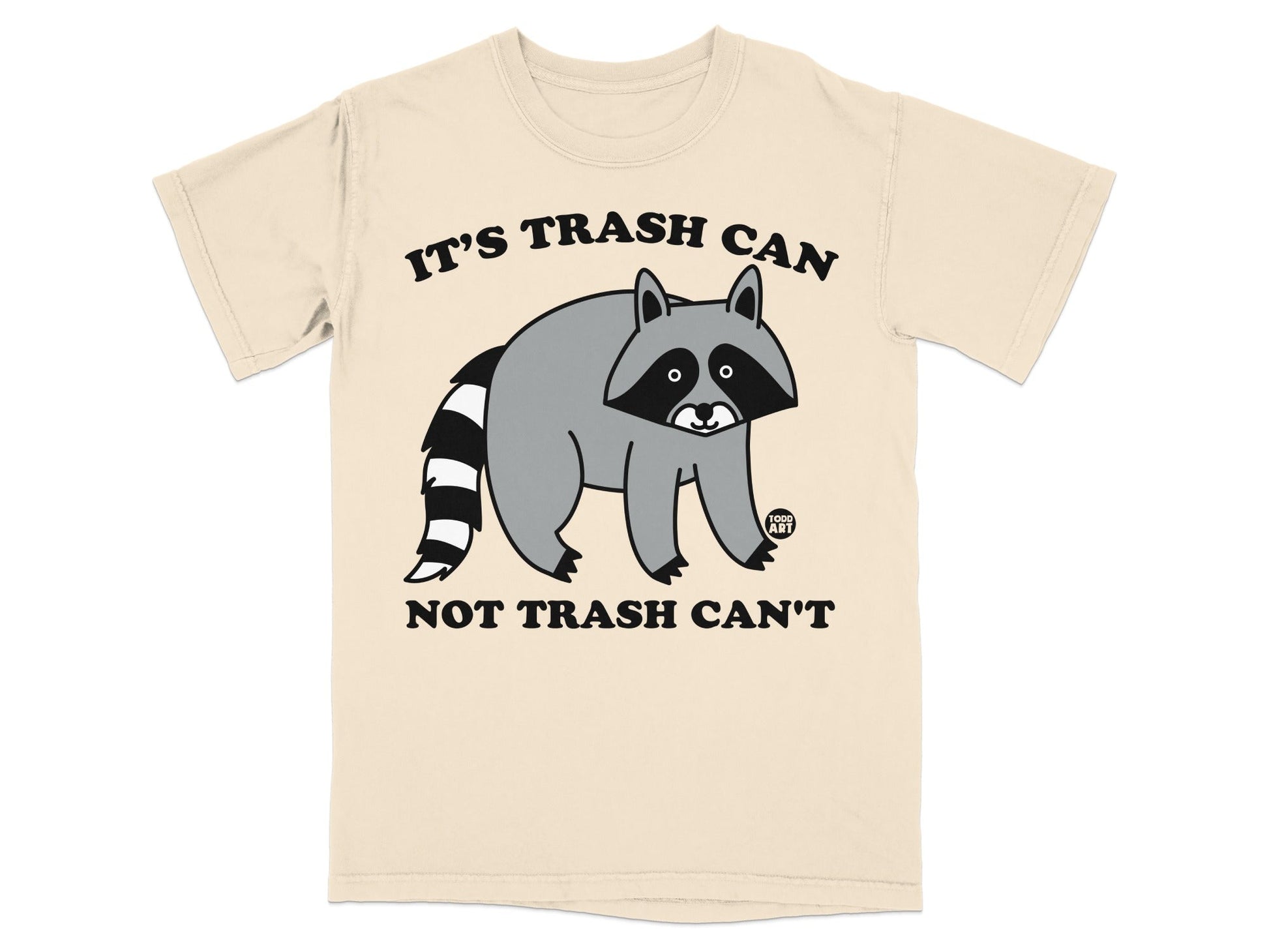 Beige t-shirt with a cartoon raccoon and text "IT'S TRASH CAN NOT TRASH CAN'T".