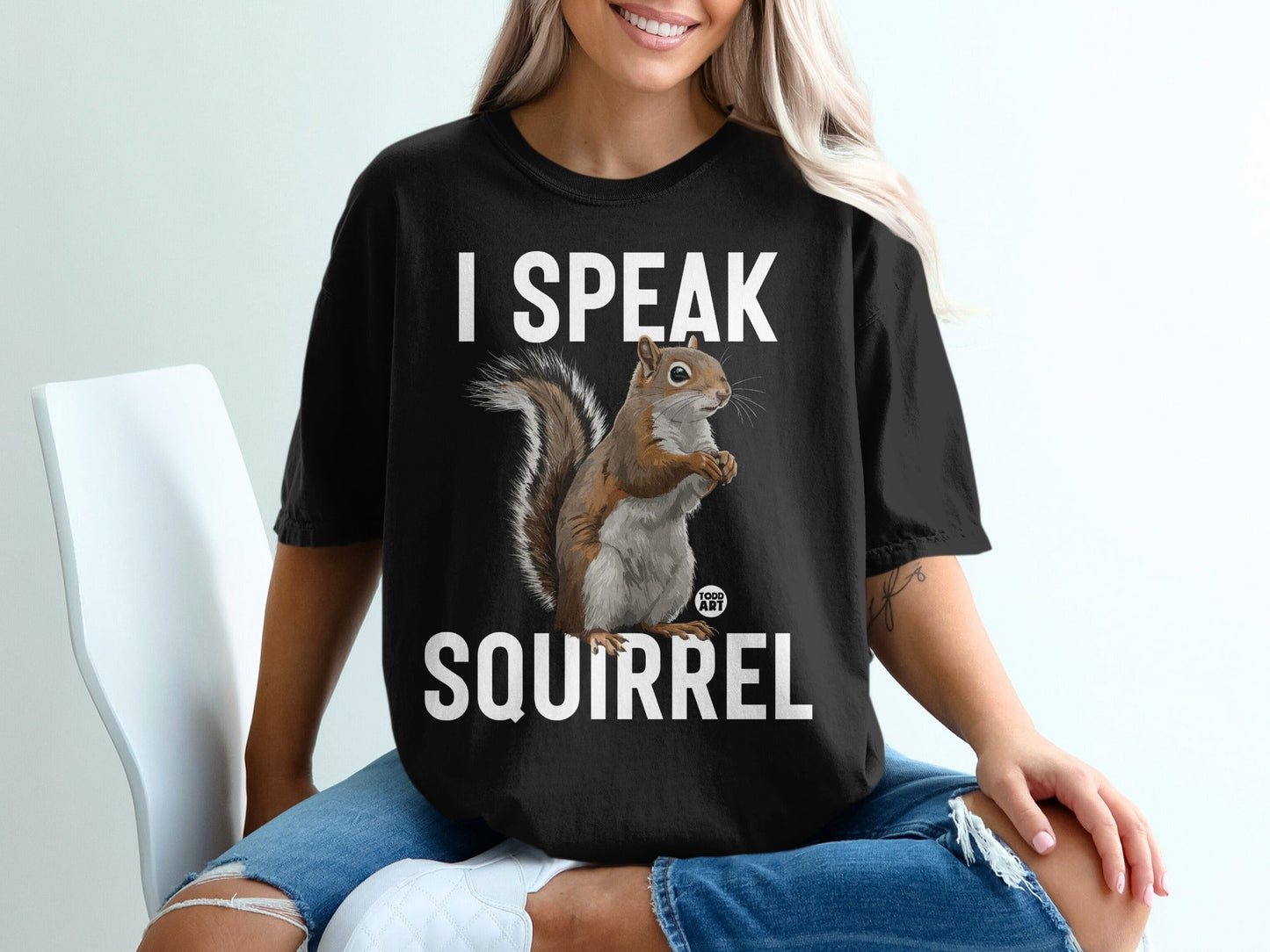 Black t-shirt with white text "I SPEAK SQUIRREL" and a squirrel graphic.