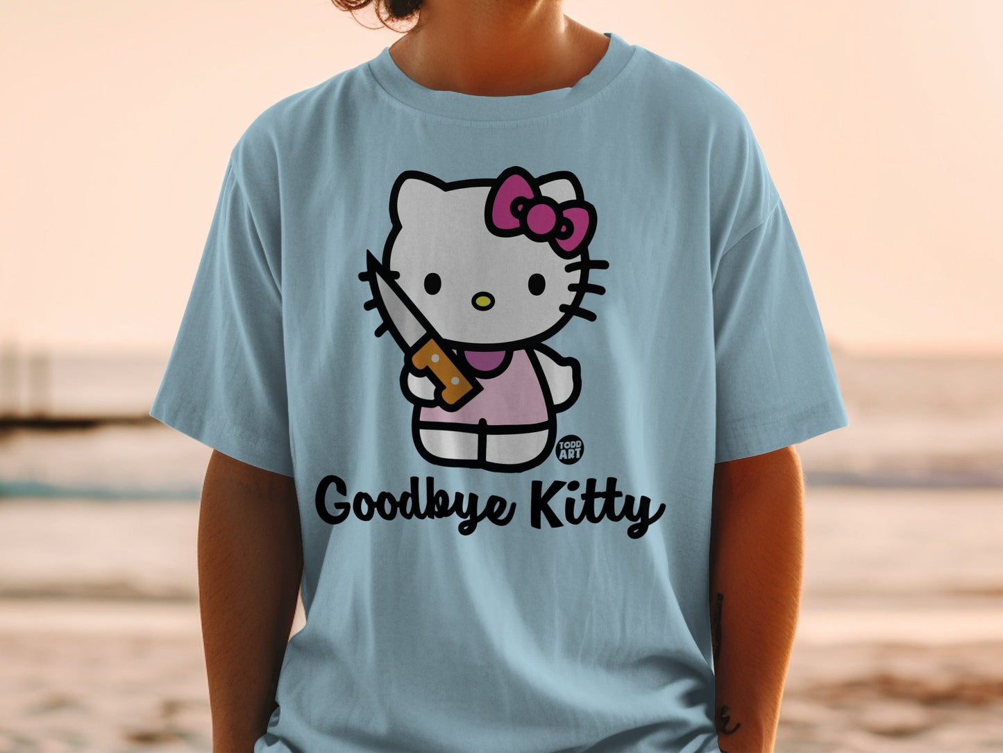 Light blue t-shirt with Hello Kitty holding a knife and the text "Goodbye Kitty".