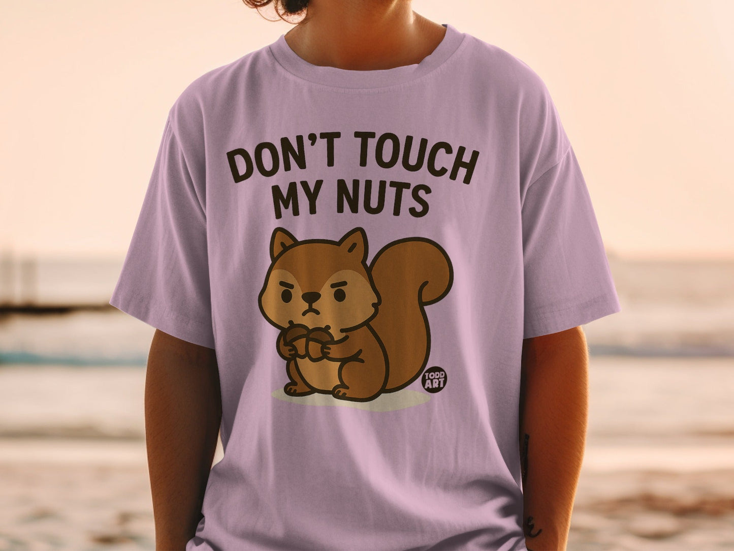 Lilac t-shirt with cartoon squirrel and text "Don't Touch My Nuts".