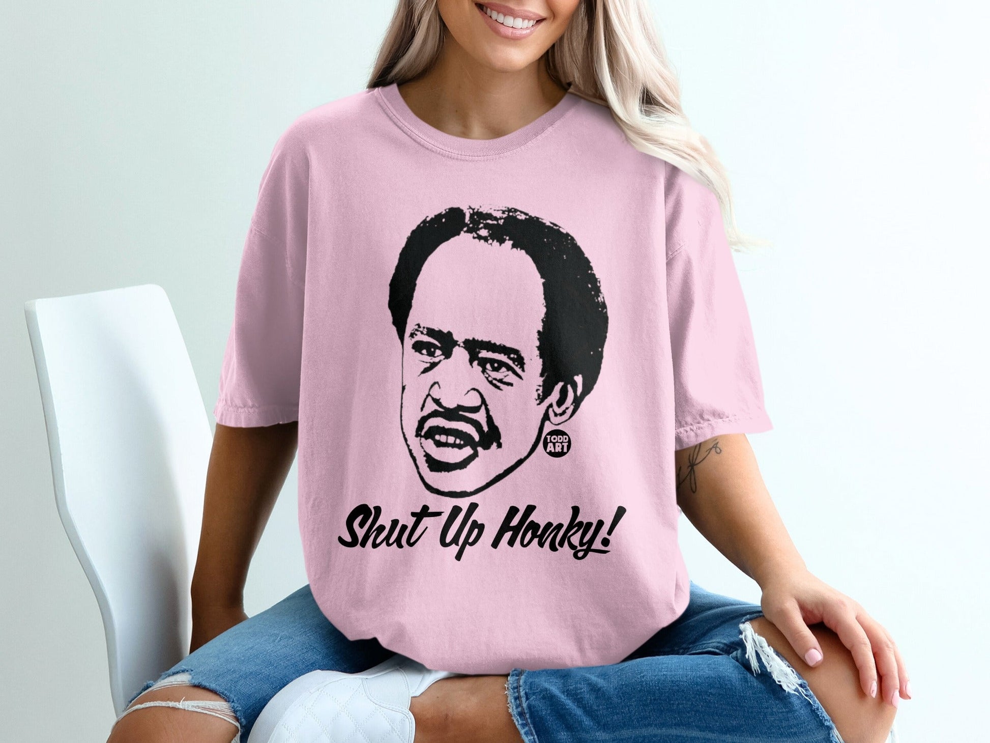 Pink t-shirt with a caricature of Richard Pryor saying "Shut Up Honky!".