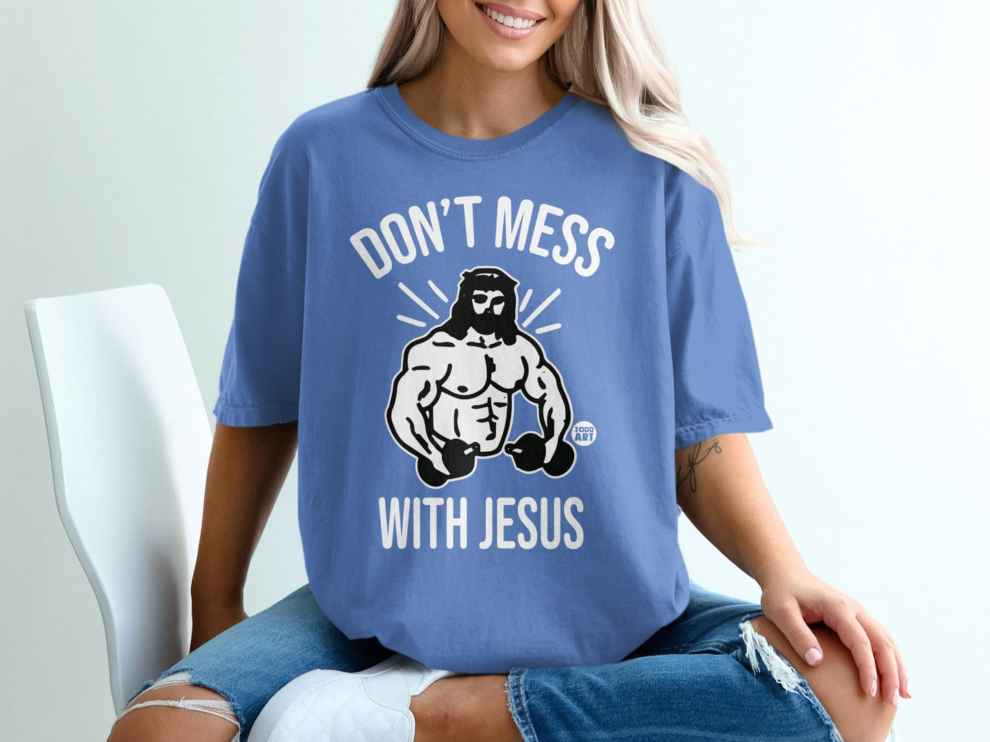 Blue t-shirt with "Don't Mess With Jesus" text and muscular Jesus graphic.