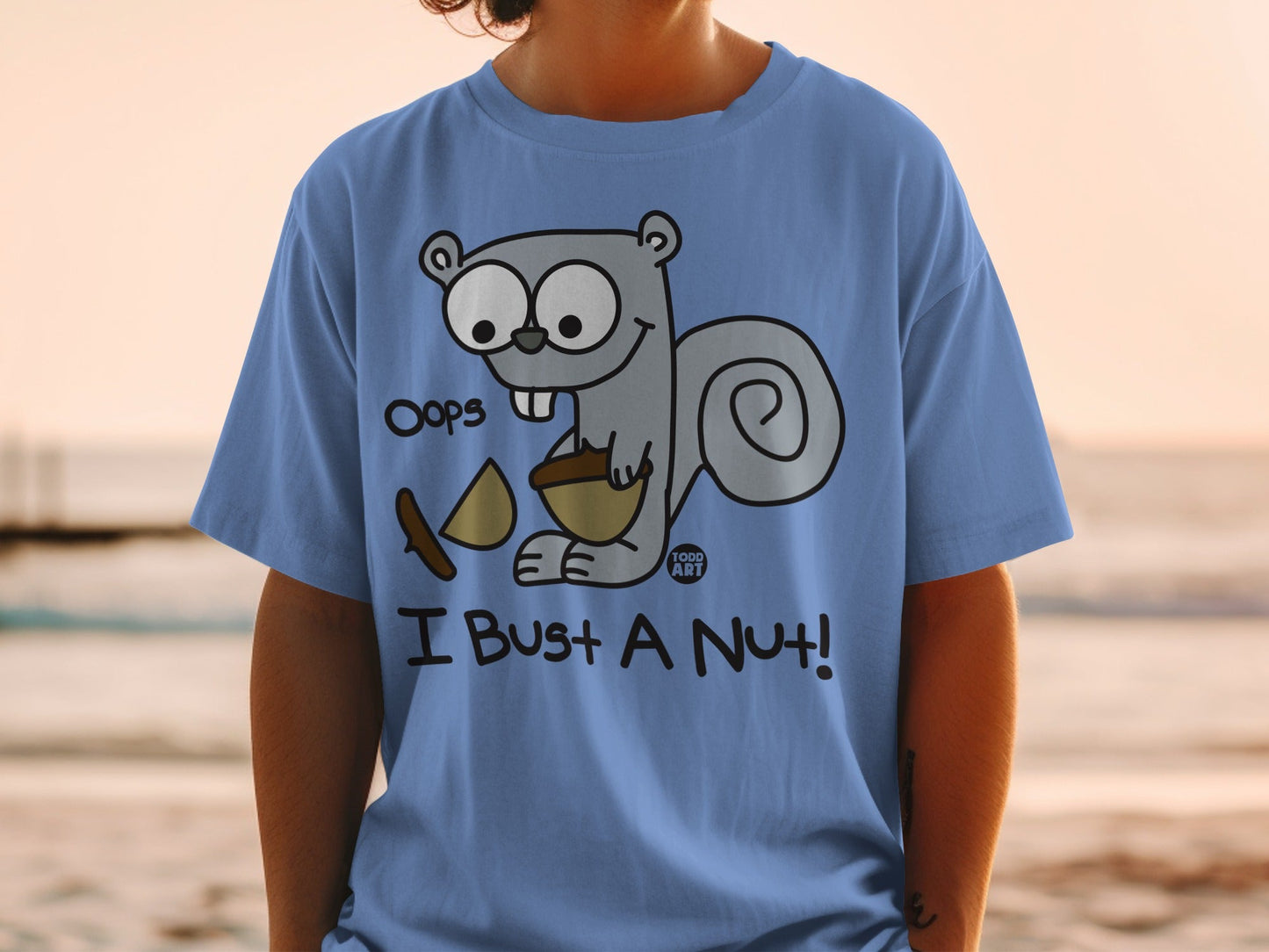 Blue t-shirt with a cartoon squirrel saying "Oops! I Bust a Nut!".