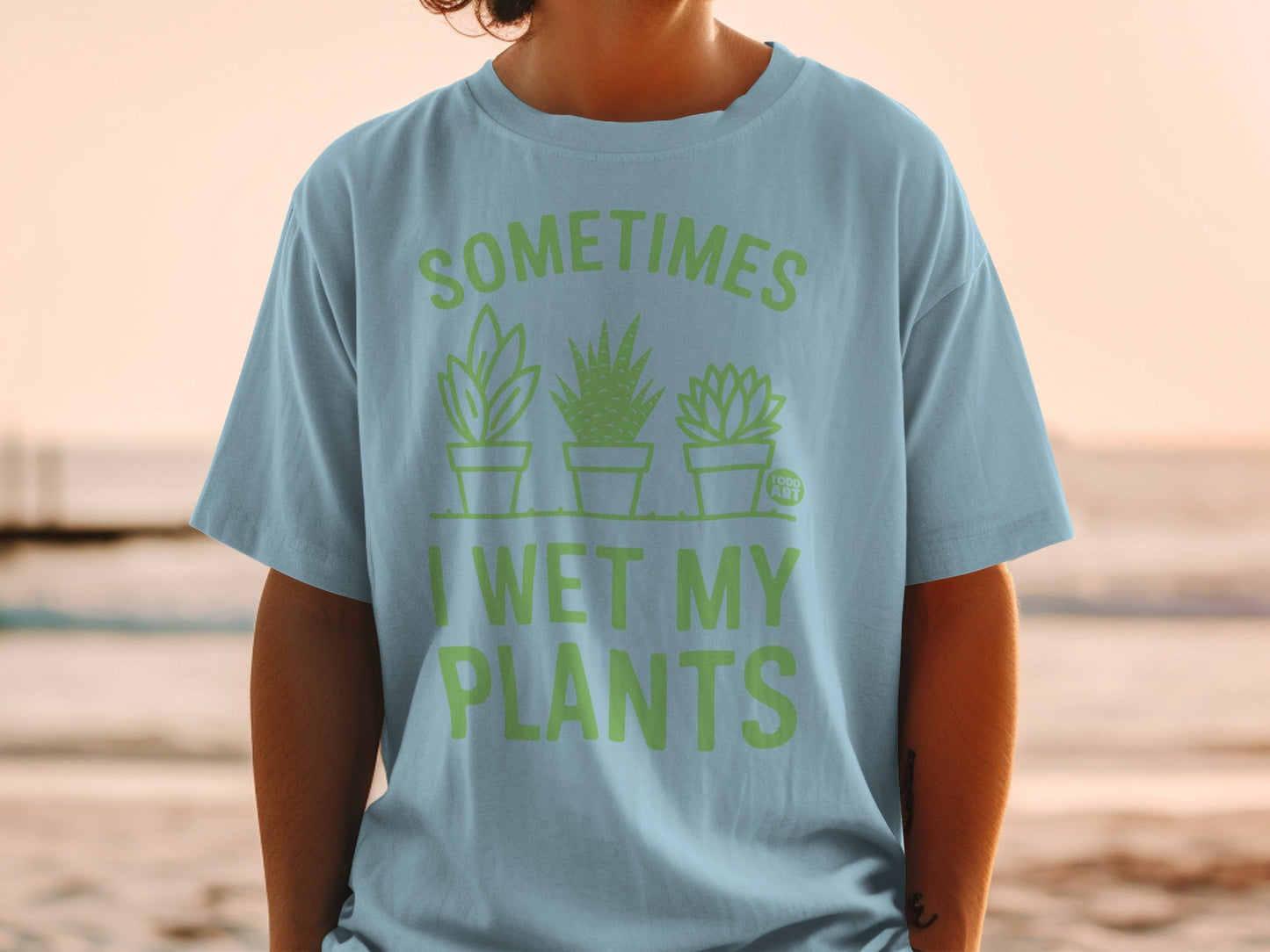 Light blue t-shirt with "SOMETIMES I WET MY PLANTS" and three potted plants.
