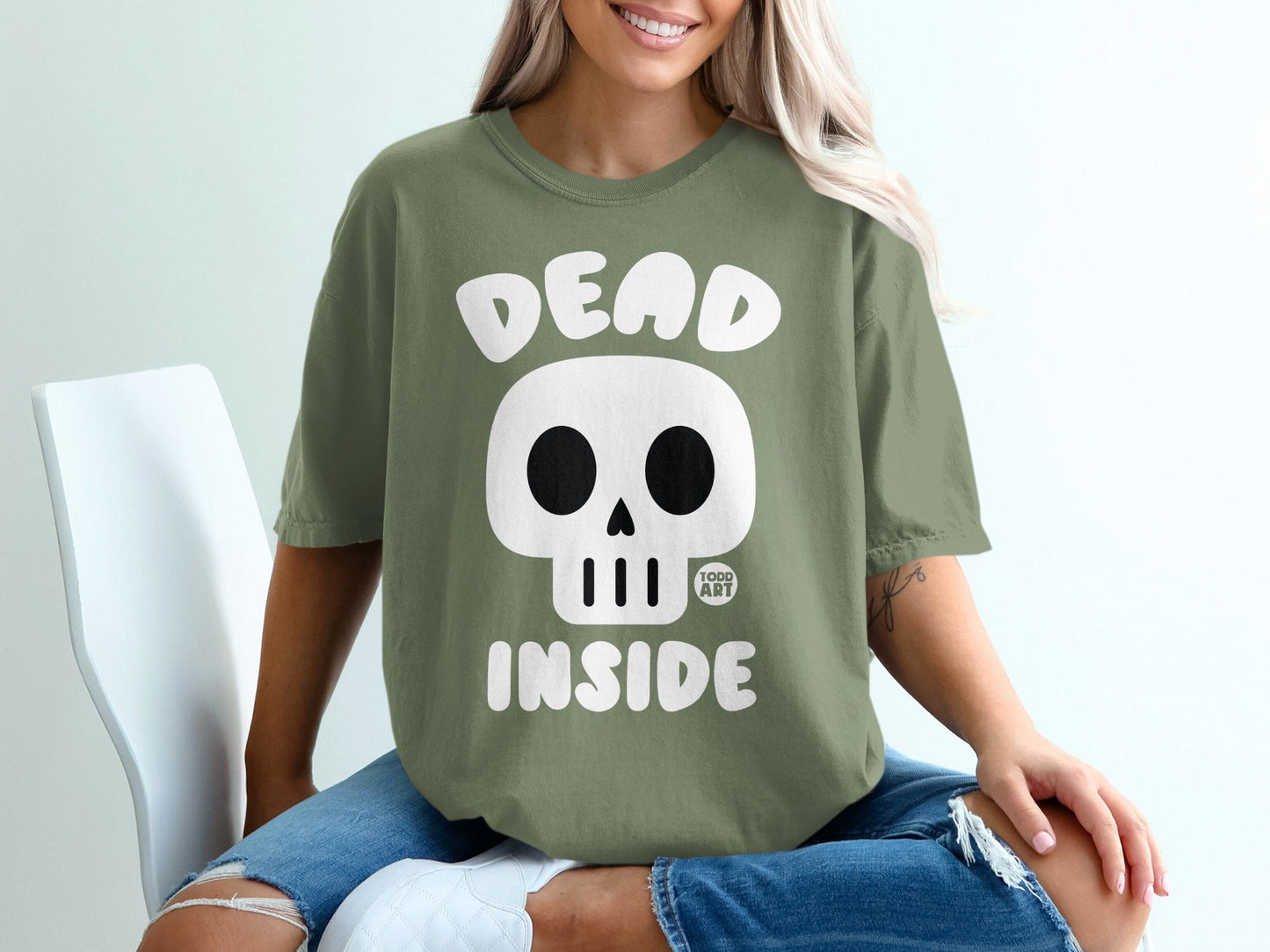 Green t-shirt with skull graphic and text "DEAD INSIDE".