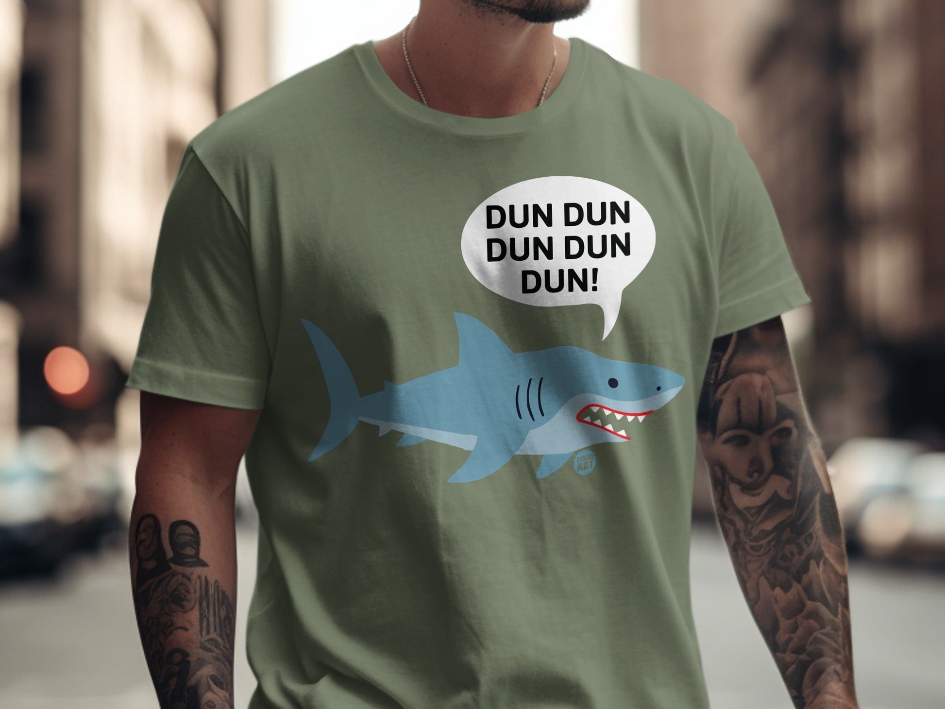 Green t-shirt with a cartoon shark and "DUN DUN DUN DUN!" speech bubble.