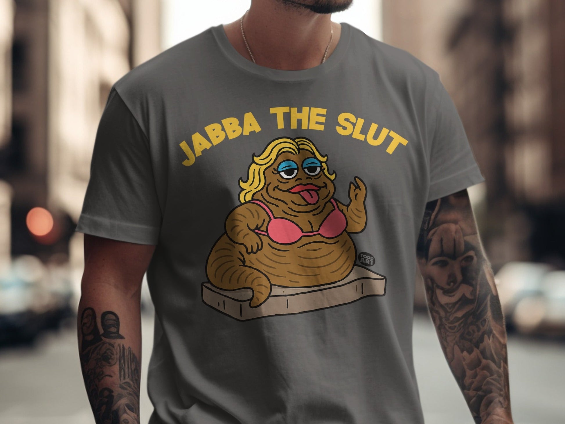 Grey t-shirt with Jabba the Slut in pink bikini on a mattress.