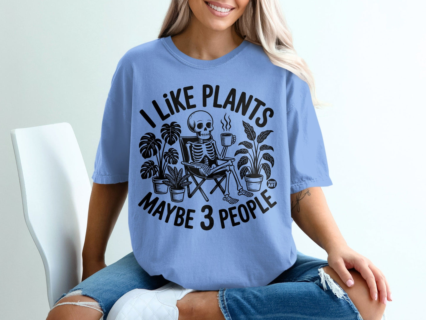 T-shirt with skeleton and plants design, "I like plants maybe 3 people" text.