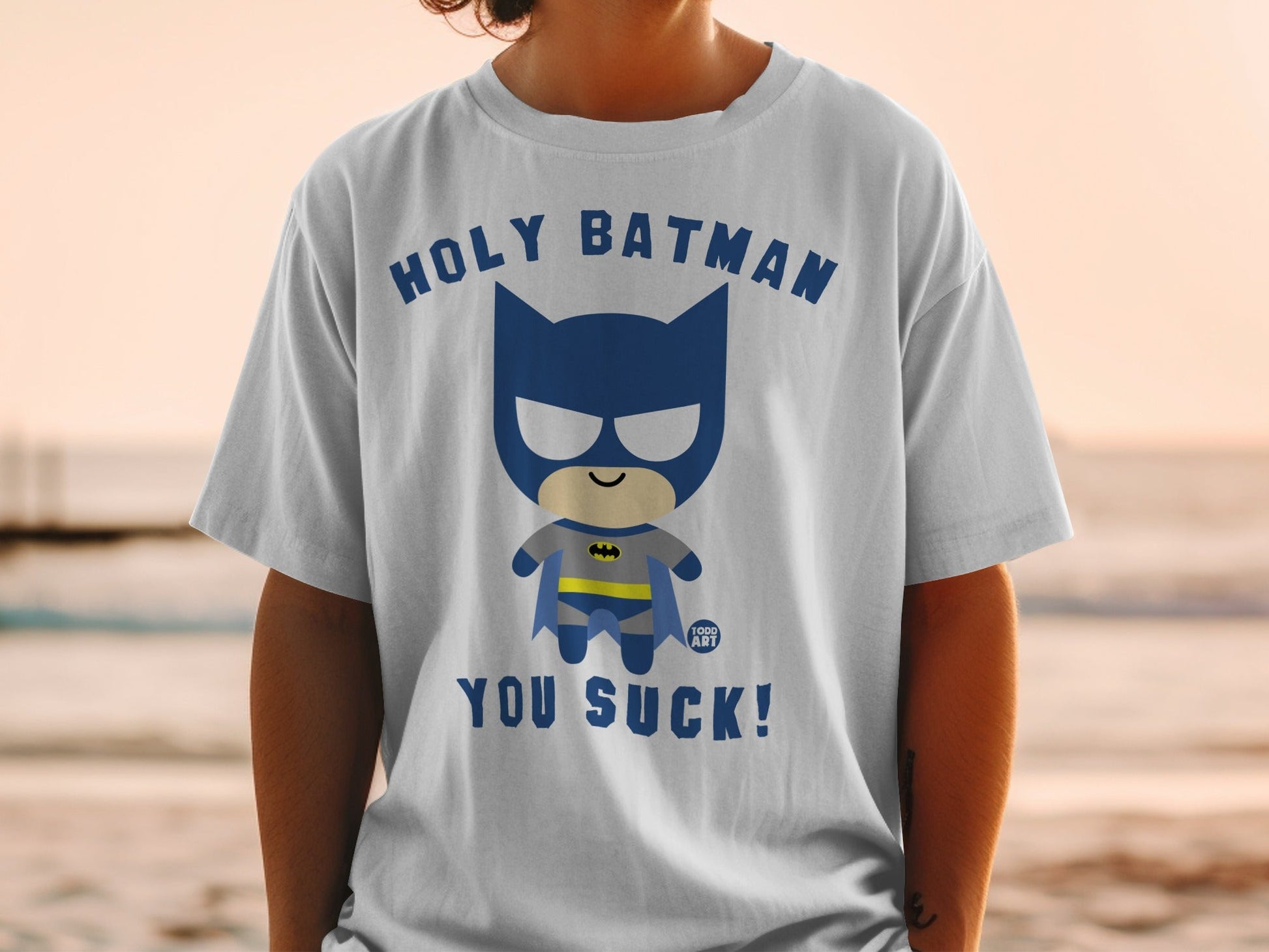 White t-shirt with cartoon Batman saying "Holy Batman, you suck!".