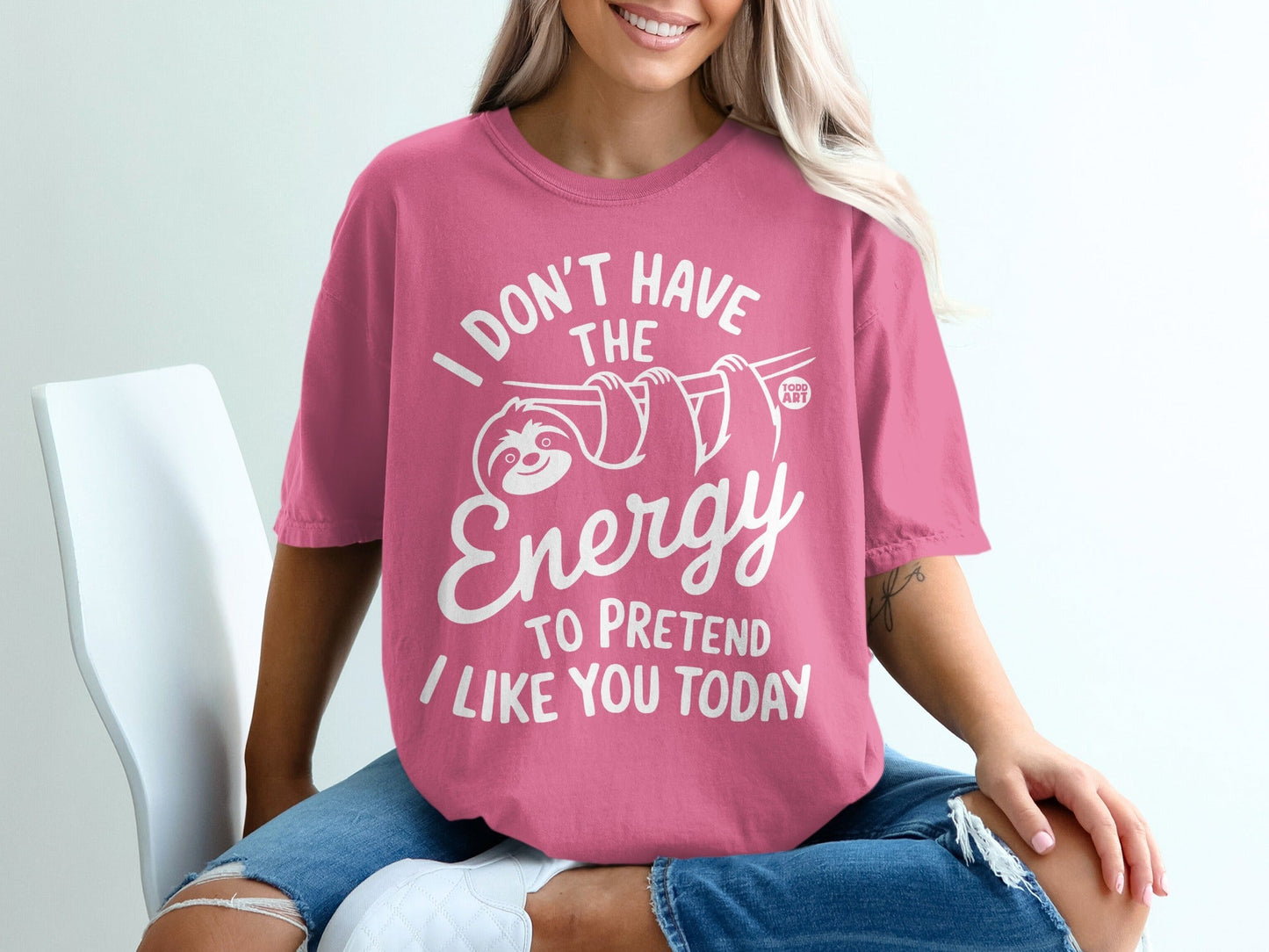 Pink t-shirt with white graphic saying "I don't have the energy to pretend I like you today".