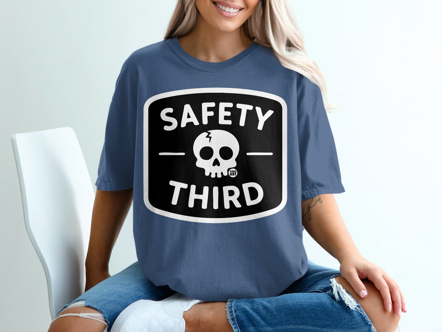 Blue t-shirt with black and white "Safety Third" skull graphic.