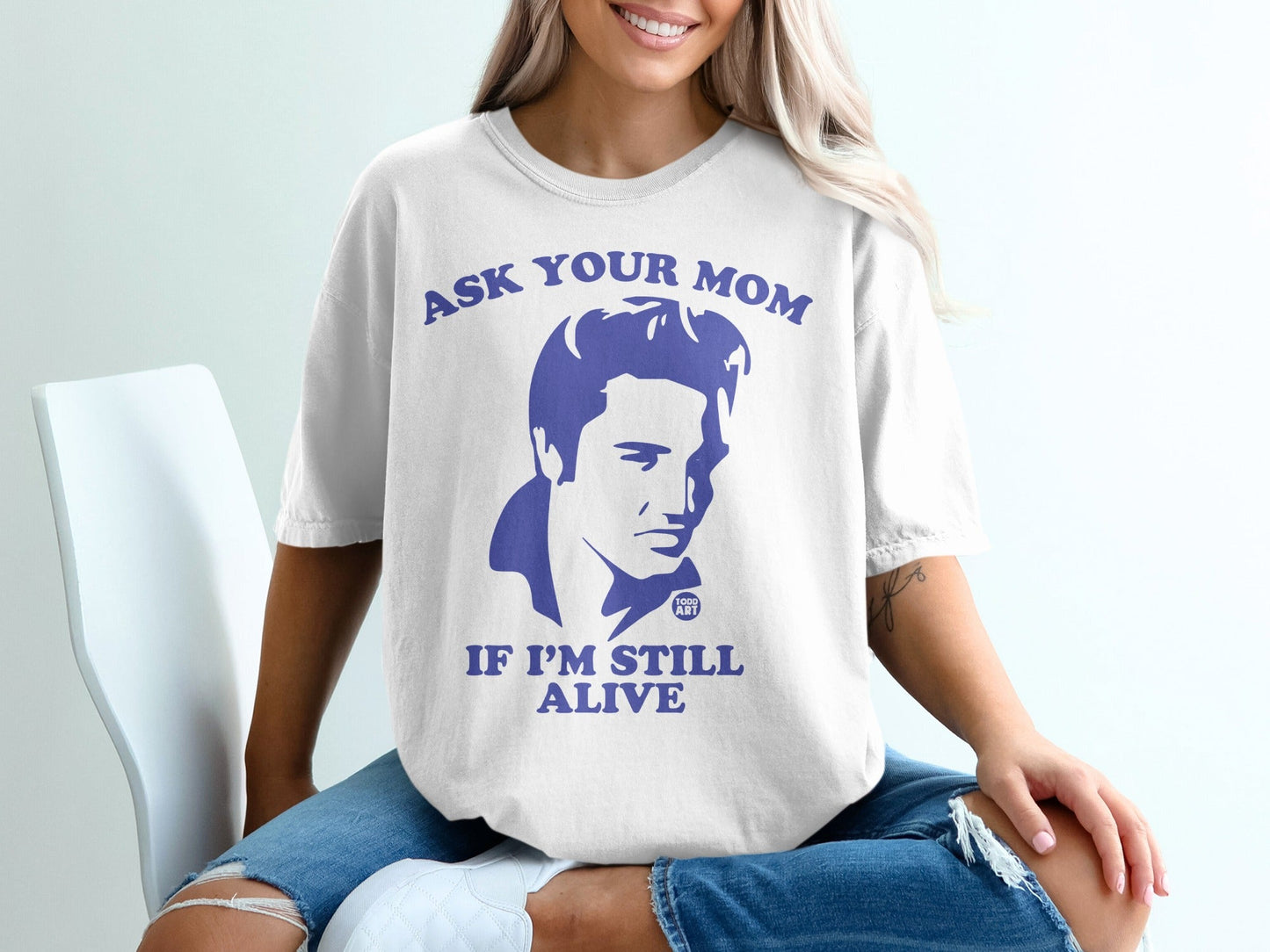 White t-shirt with "Ask Your Mom If I'm Still Alive" and Elvis Presley graphic.