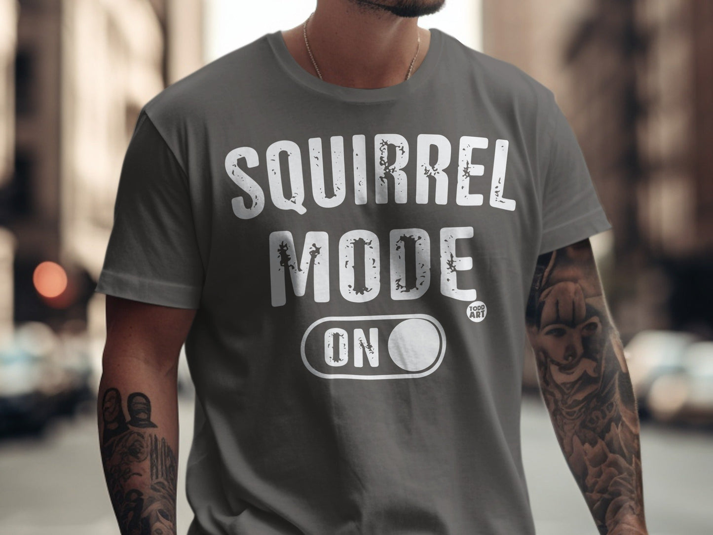 Gray t-shirt with "SQUIRREL MODE ON" text and a small "GOOD ART" logo.