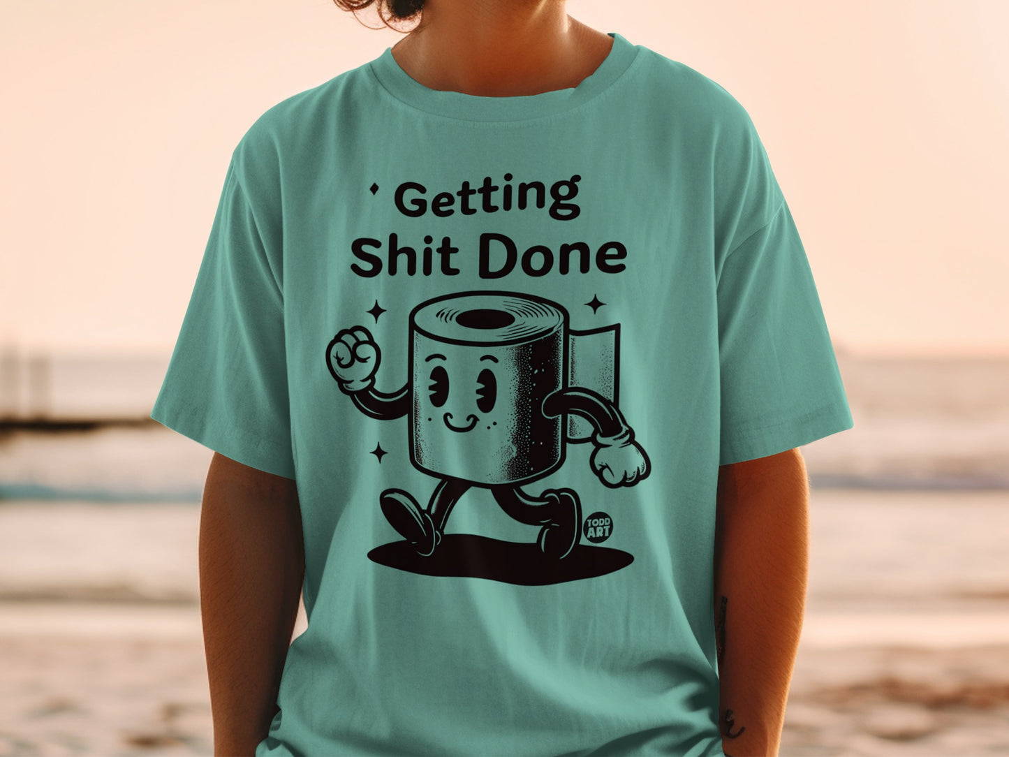 Teal t-shirt with cartoon toilet paper character saying "Getting Shit Done."
