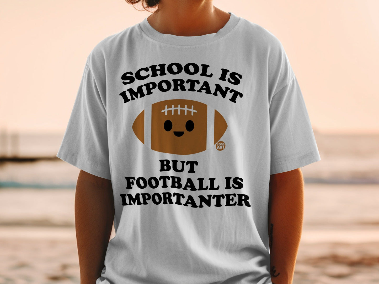 T-shirt with "SCHOOL IS IMPORTANT BUT FOOTBALL IS IMPORTANTER" and a cartoon football.