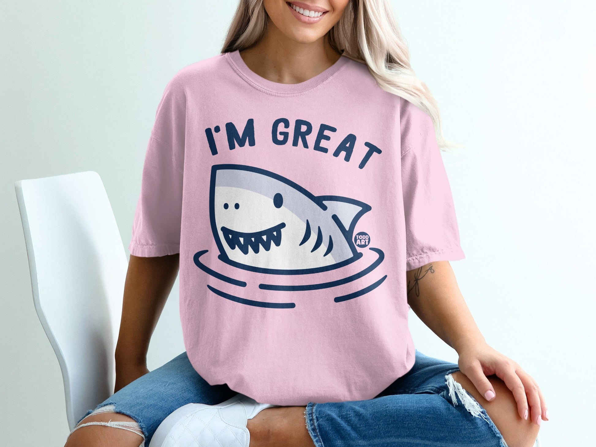 Pink t-shirt with a cartoon shark and the text "I'M GREAT".