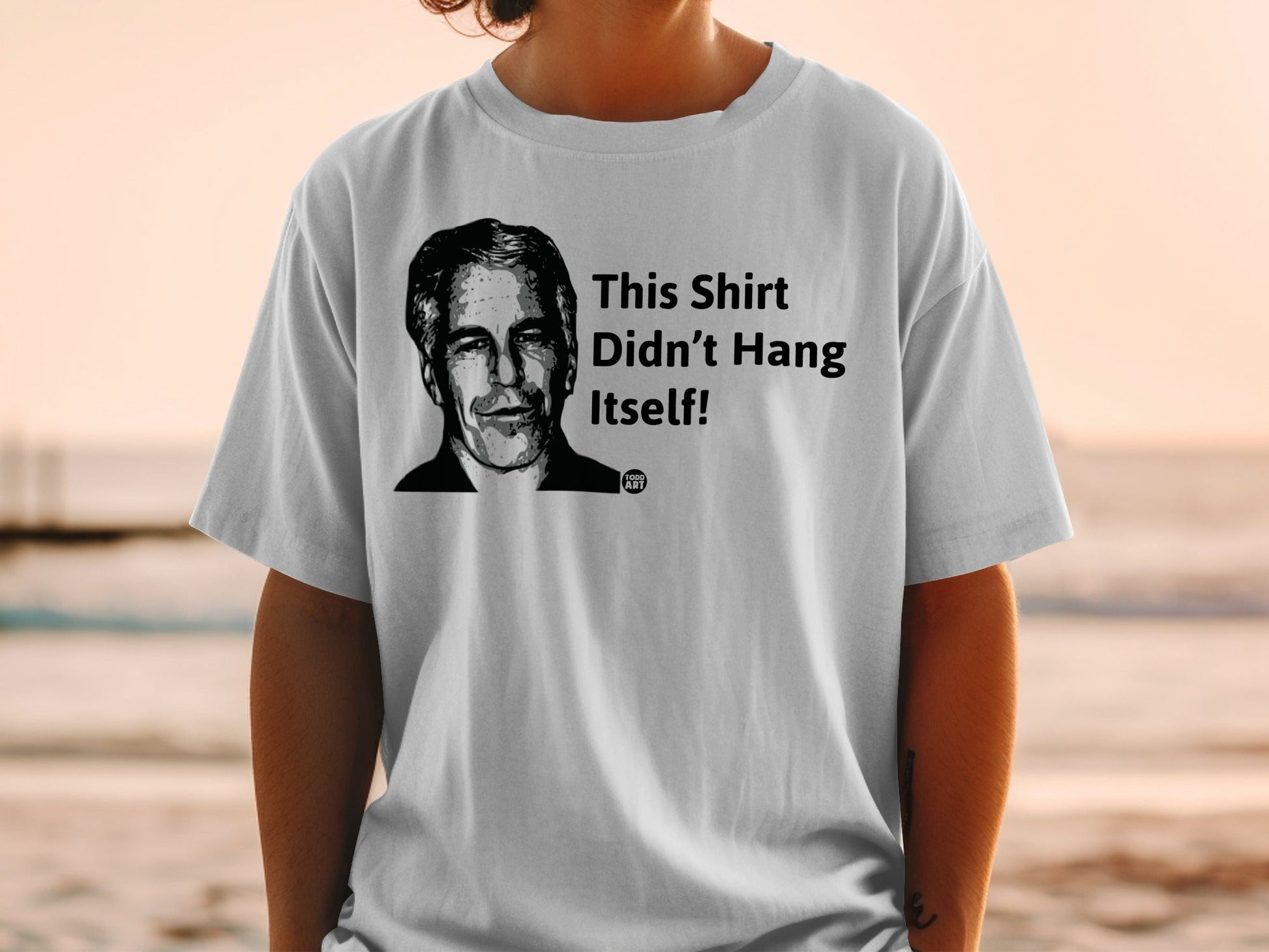 Gray t-shirt with portrait and text "This Shirt Didn't Hang Itself!"