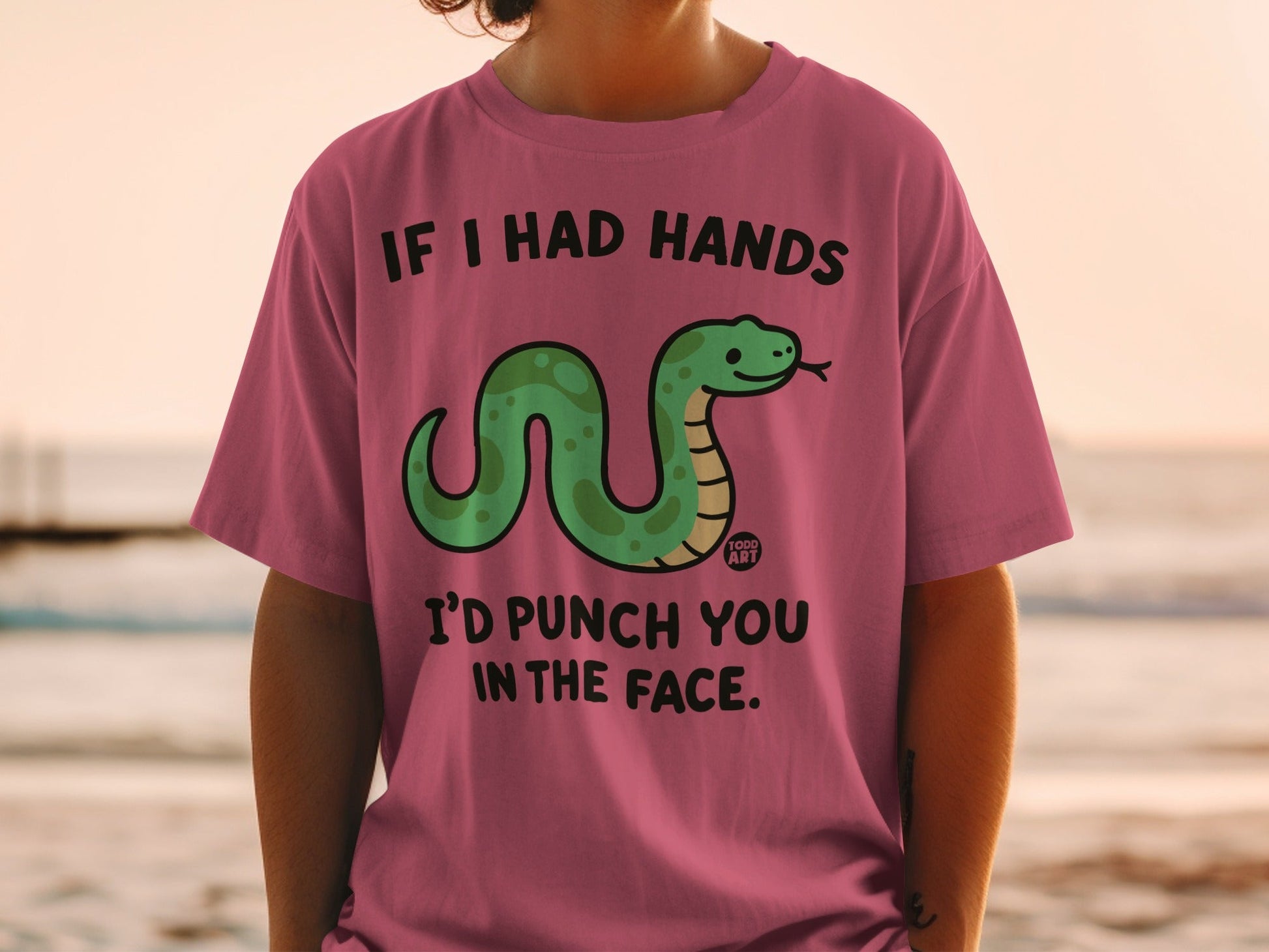 Pink t-shirt with a green snake and text: "If I Had Hands I'd Punch You in the Face."