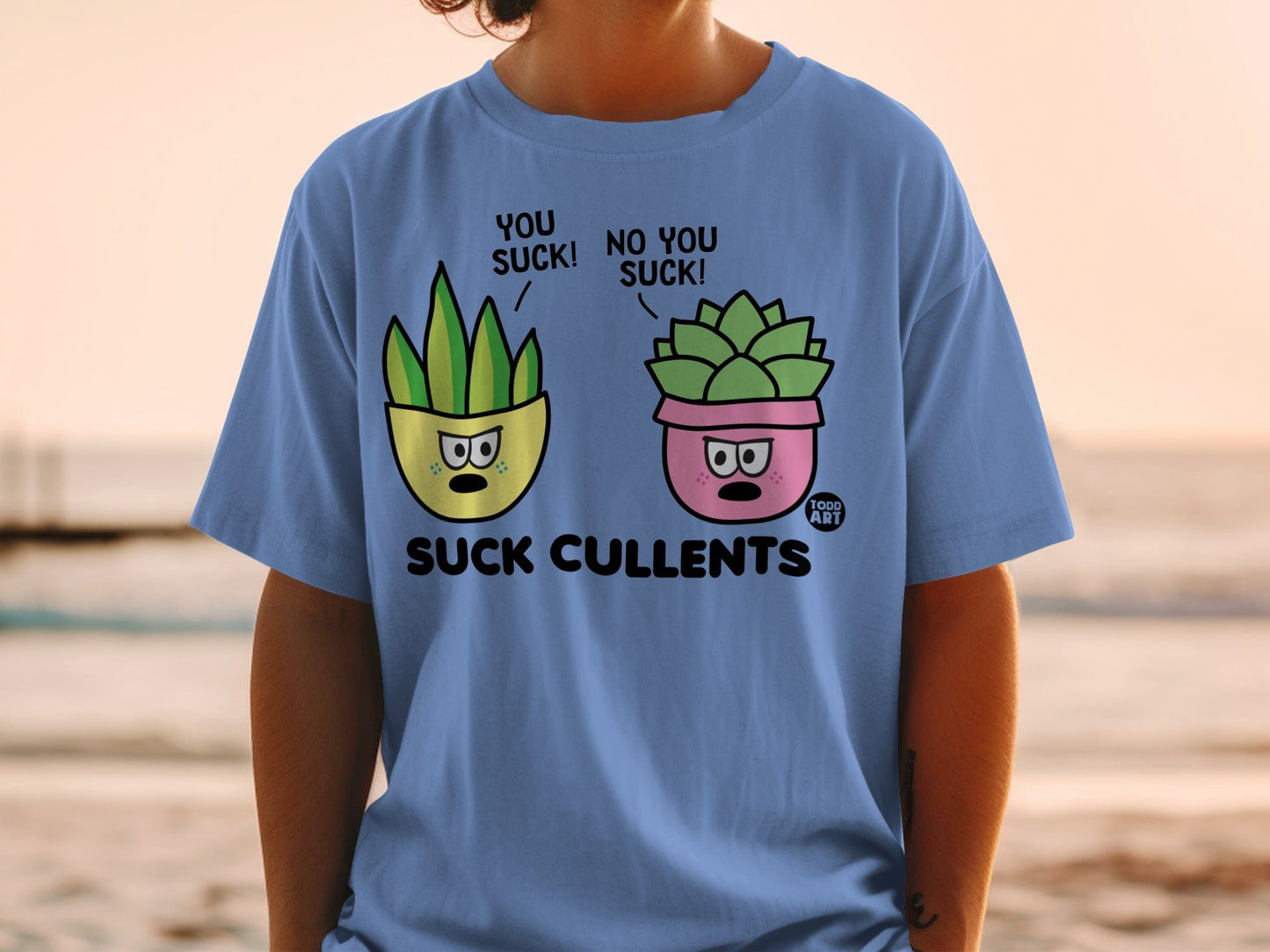 Blue t-shirt with cartoon succulents saying "YOU SUCK!" and "NO YOU SUCK!".