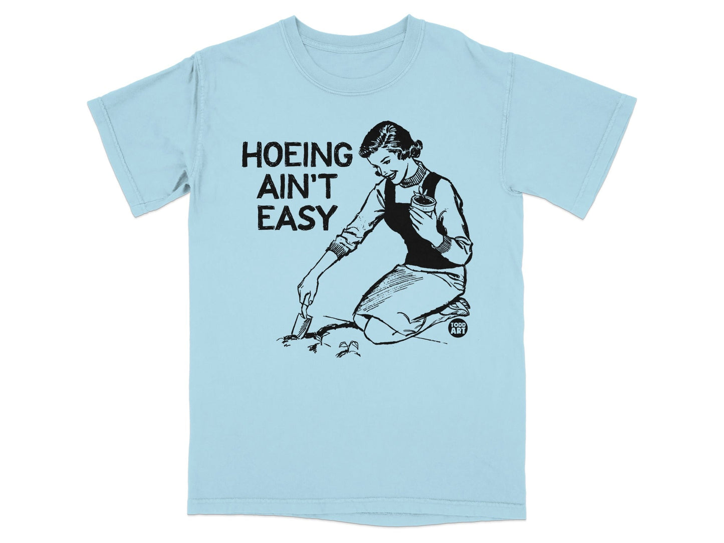 T-shirt with black line drawing of a woman gardening, text reads "HOEING AIN'T EASY".