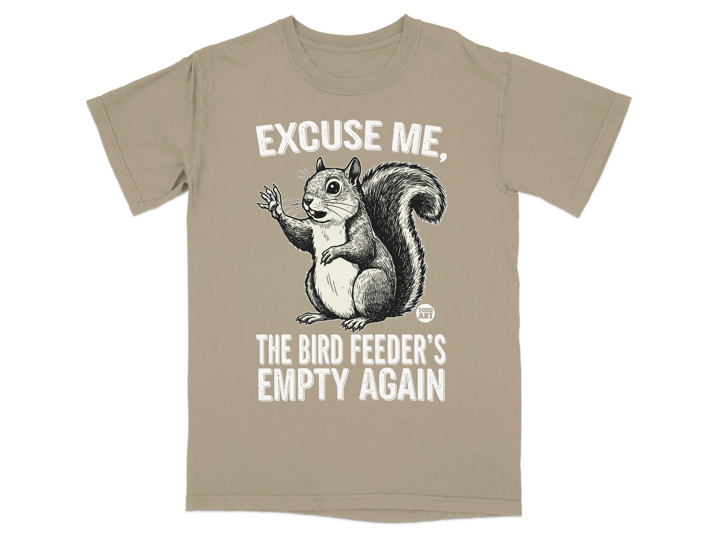 Squirrel graphic on a tan t-shirt saying "Excuse me, the bird feeder's empty again."