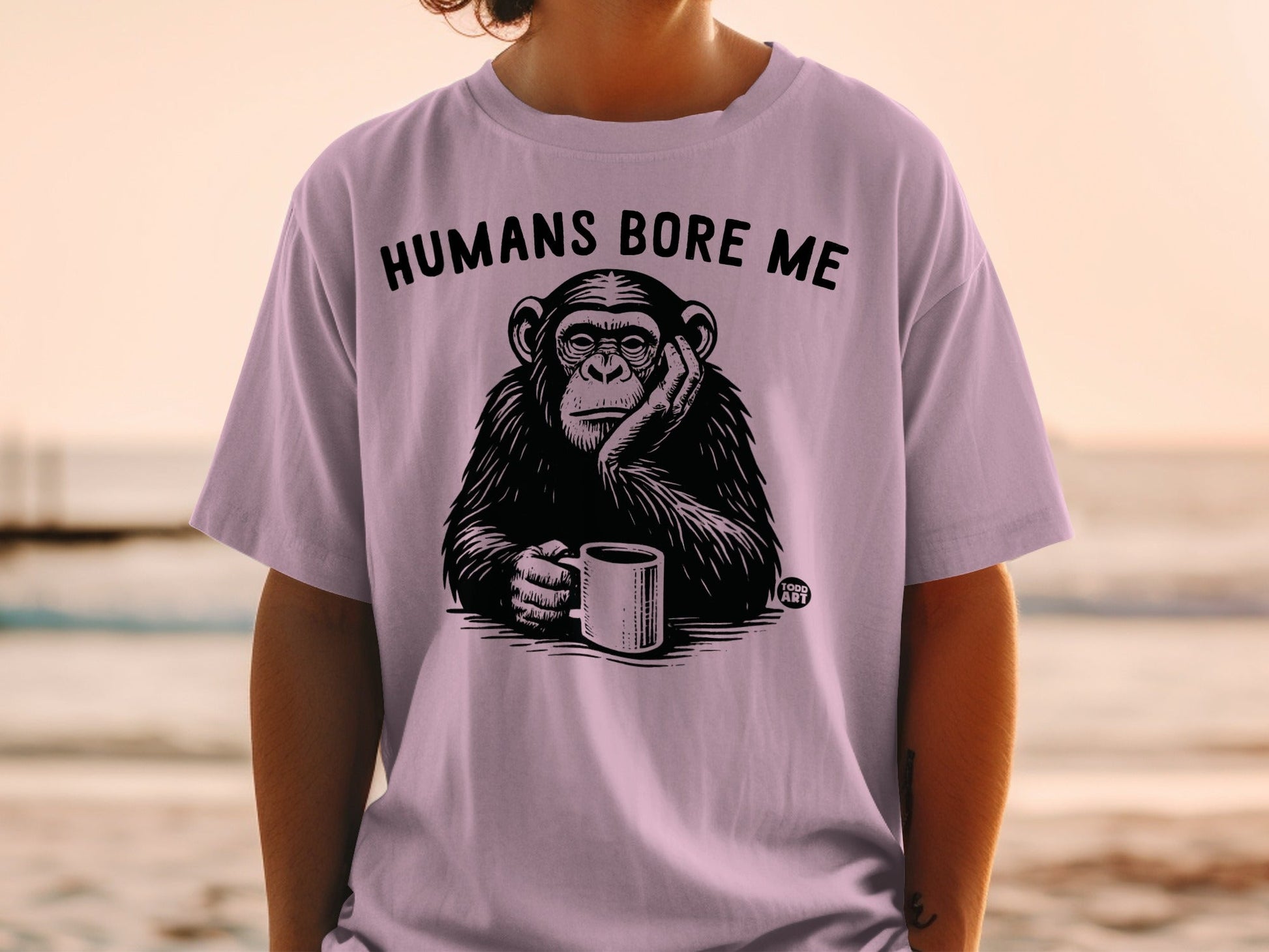 T-shirt with chimpanzee holding coffee cup and text "HUMANS BORE ME".