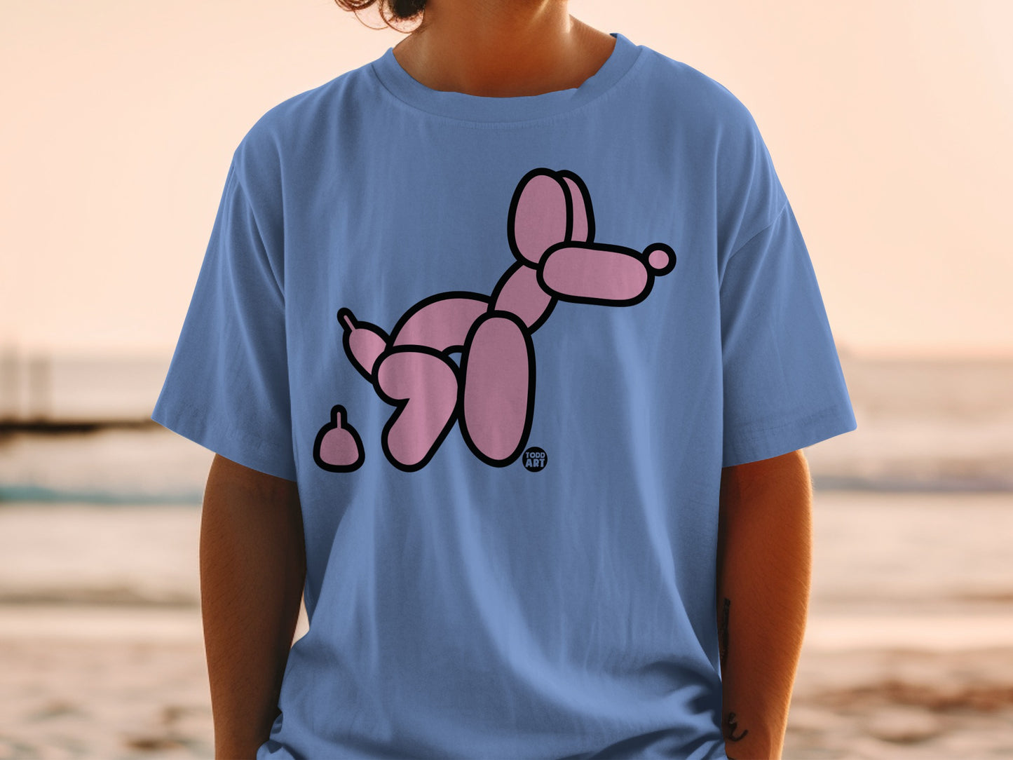 Blue t-shirt with a pink balloon dog and poop emoji.
