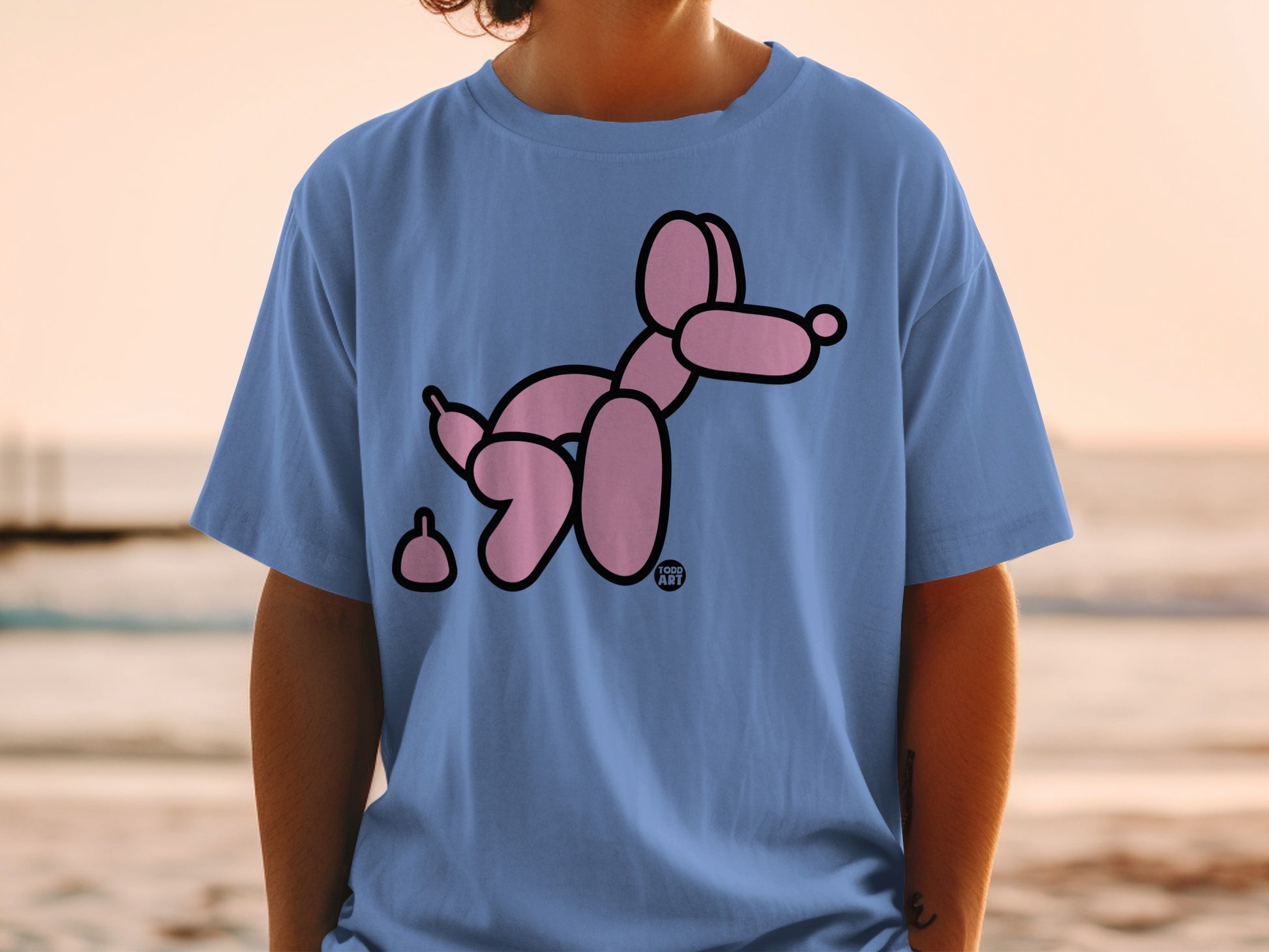 Blue t-shirt with a pink balloon dog and poop emoji.