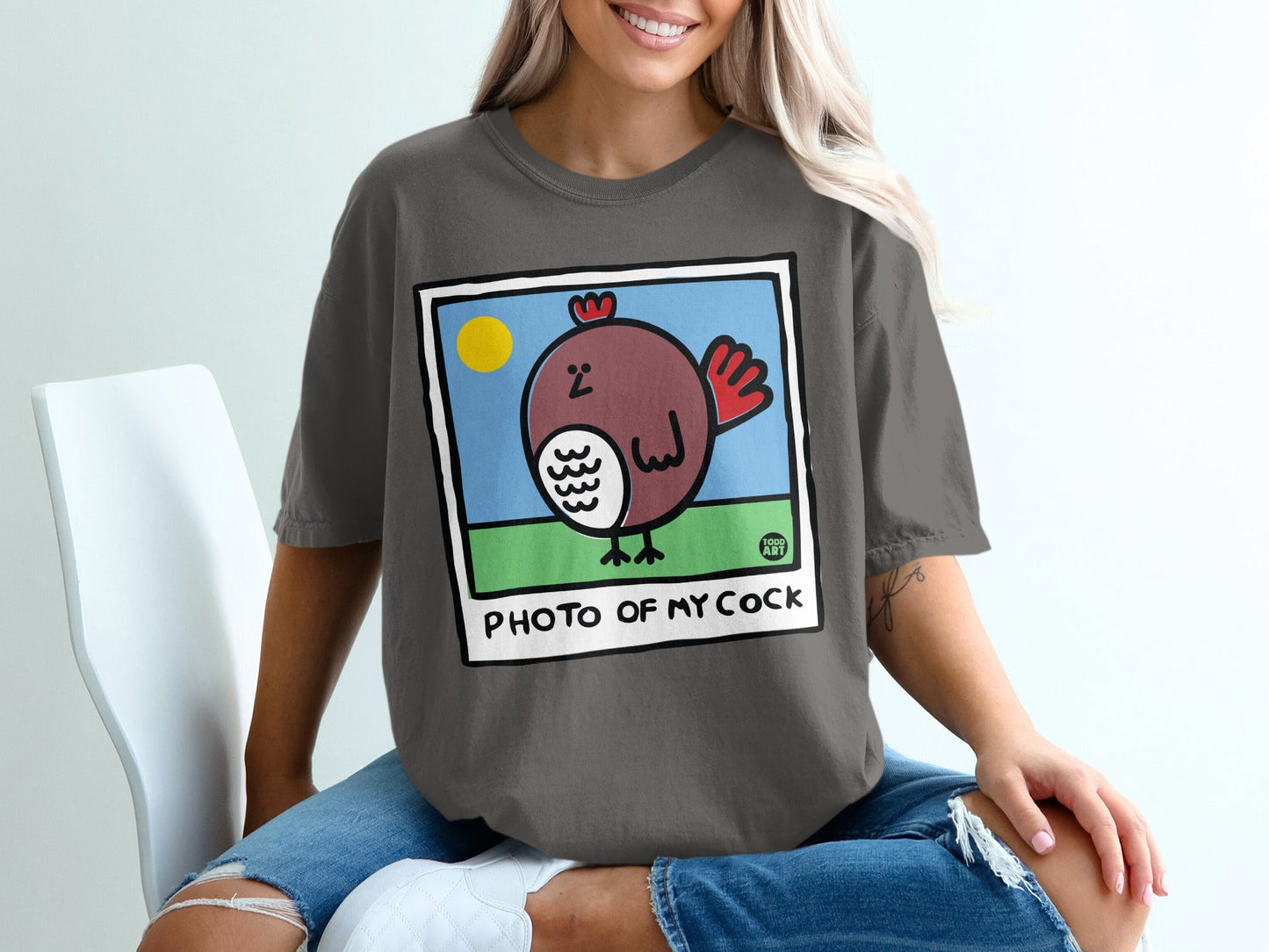 Cartoon chicken in a picture frame on a t-shirt.