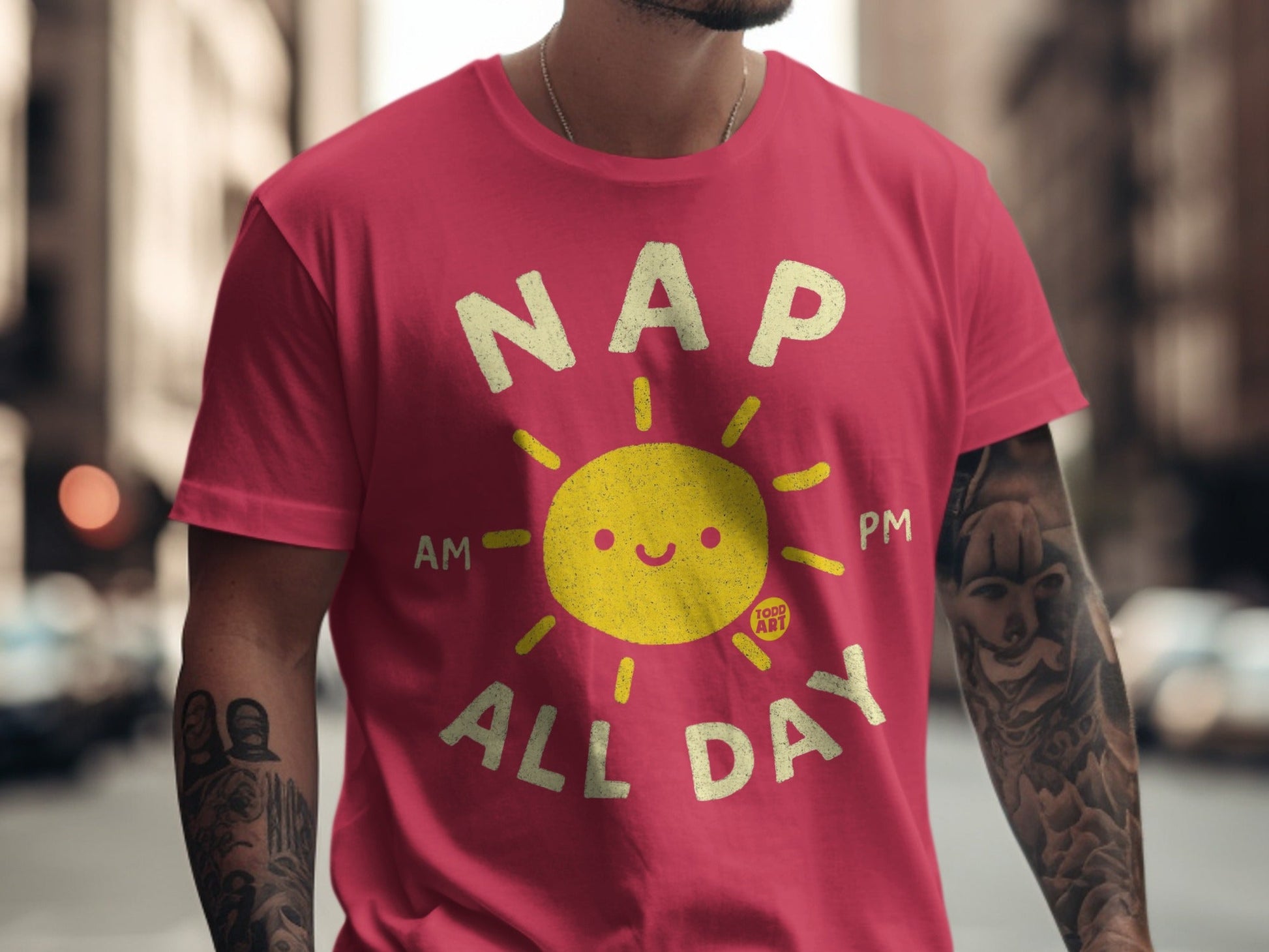 Red t-shirt with "NAP ALL DAY" and a smiling sun graphic.