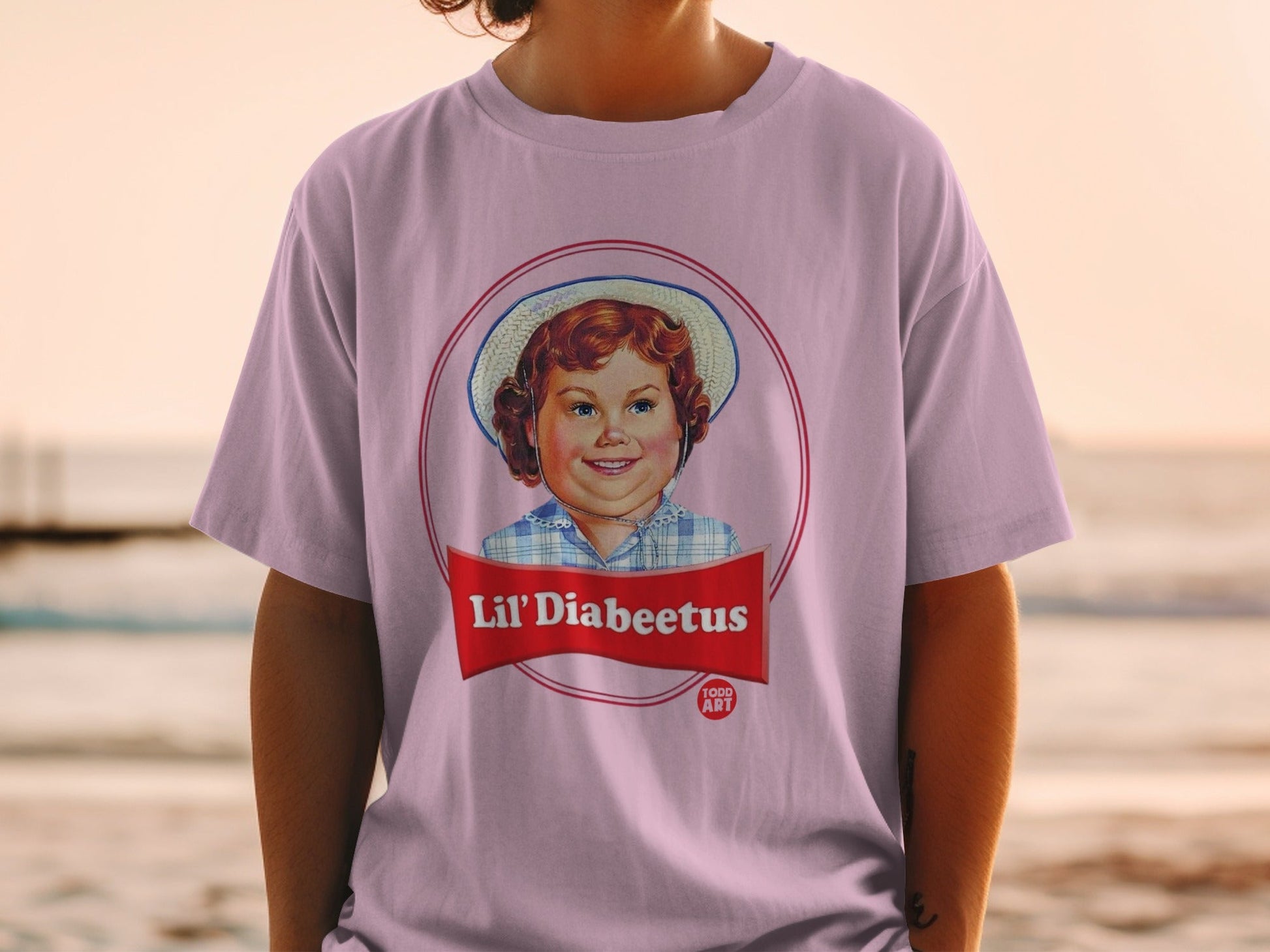 T-shirt with a circular graphic of a smiling child in a hat and text "Lil' Diabeetus".