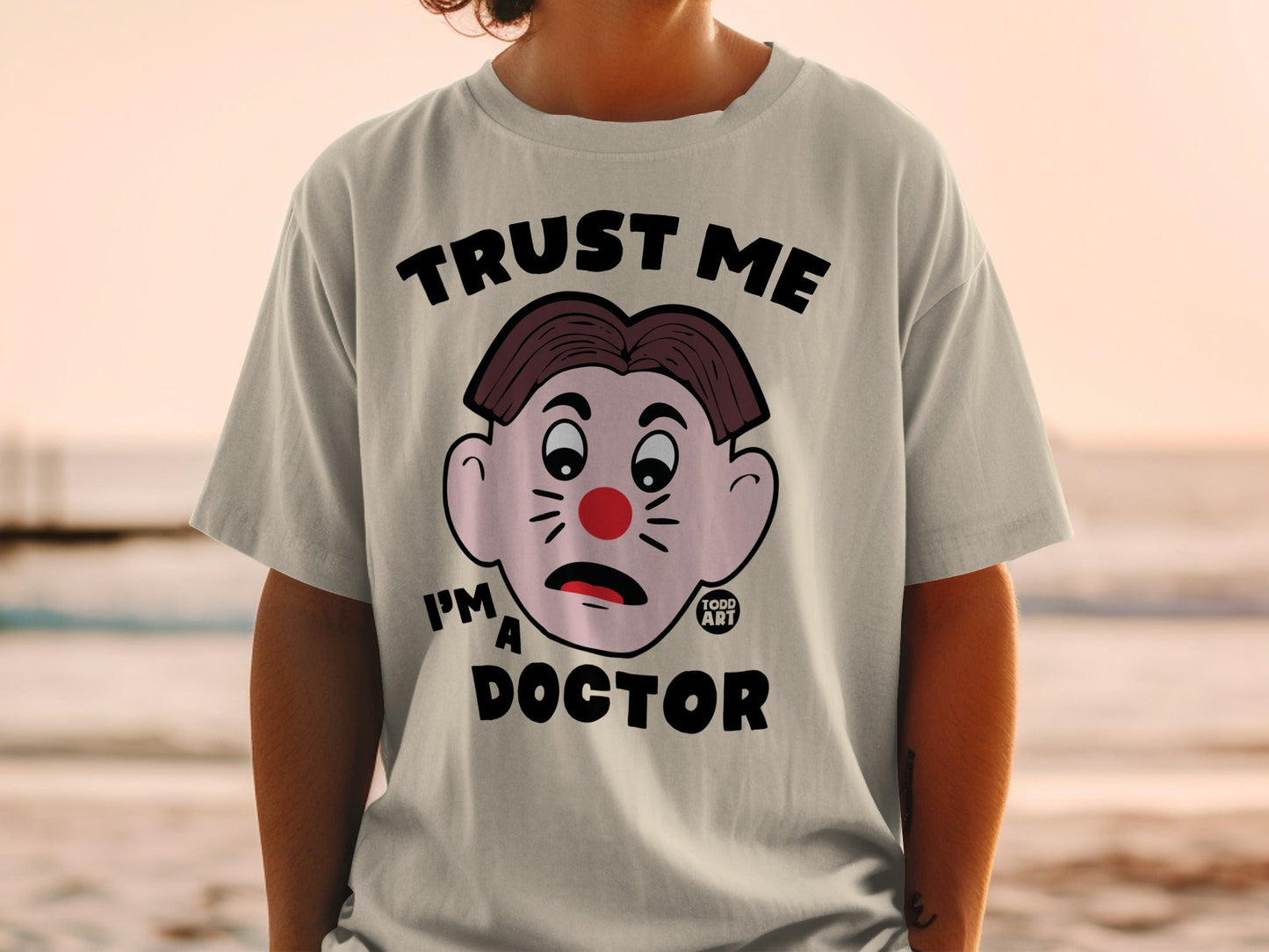 T-shirt with cartoon clown face and "Trust Me I'm a Doctor" text.