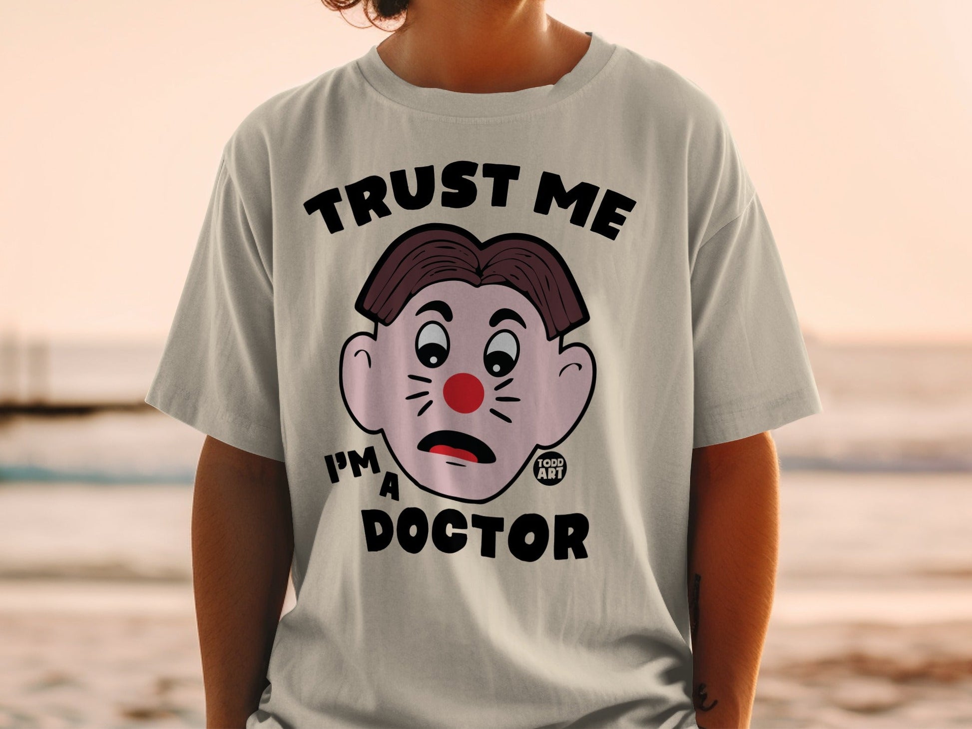 T-shirt with cartoon clown face and "Trust Me I'm a Doctor" text.