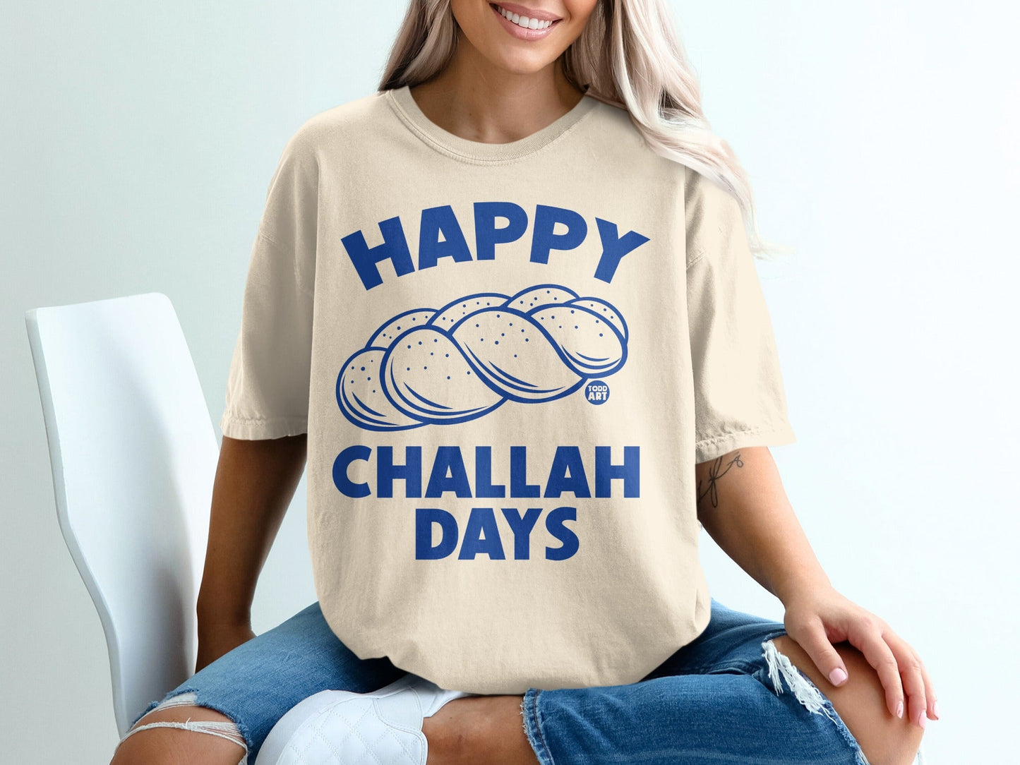Cream t-shirt with "Happy Challah Days" and braided challah bread graphic.