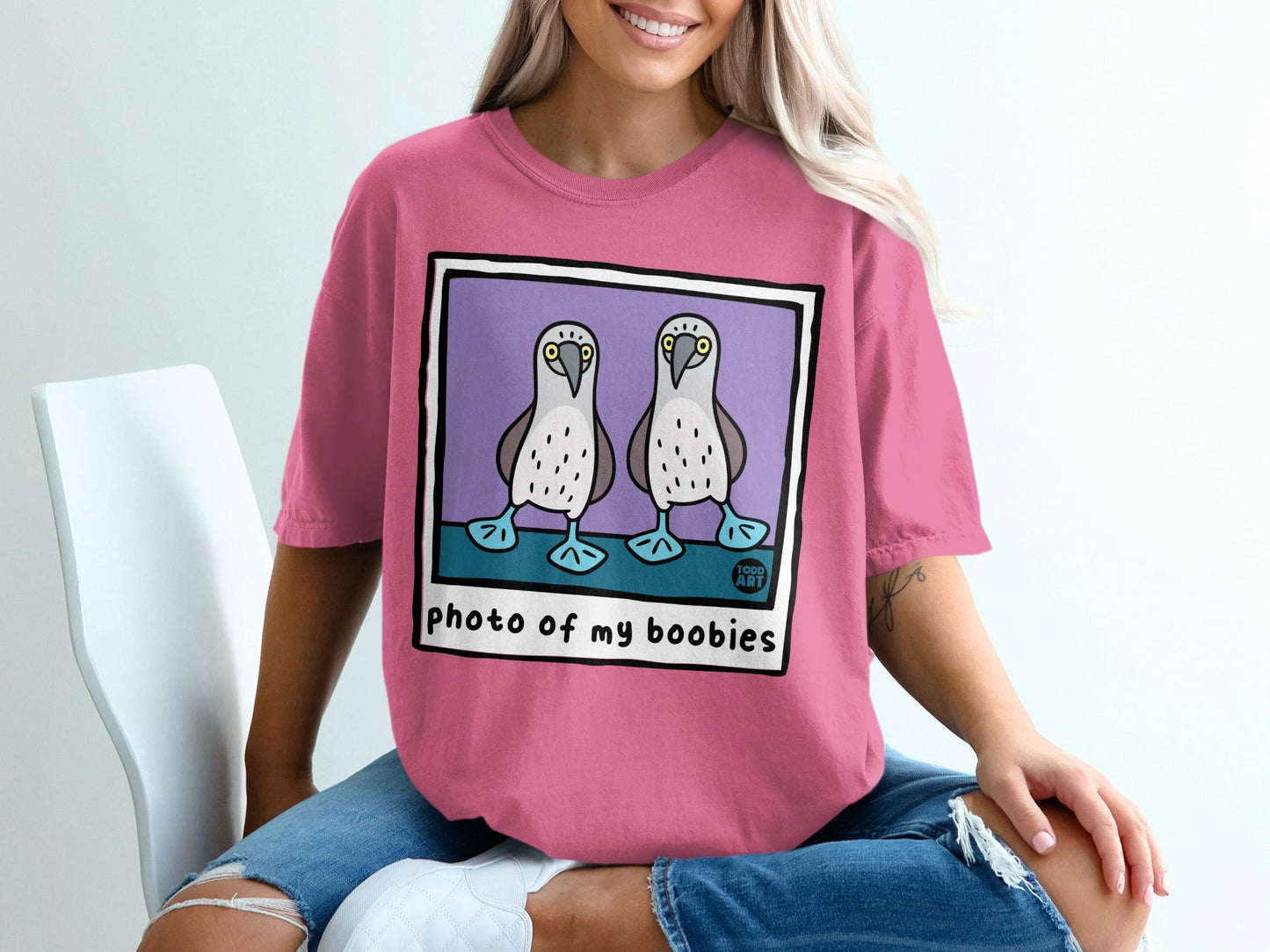 Pink t-shirt with cartoon boobies and "photo of my boobies" text.