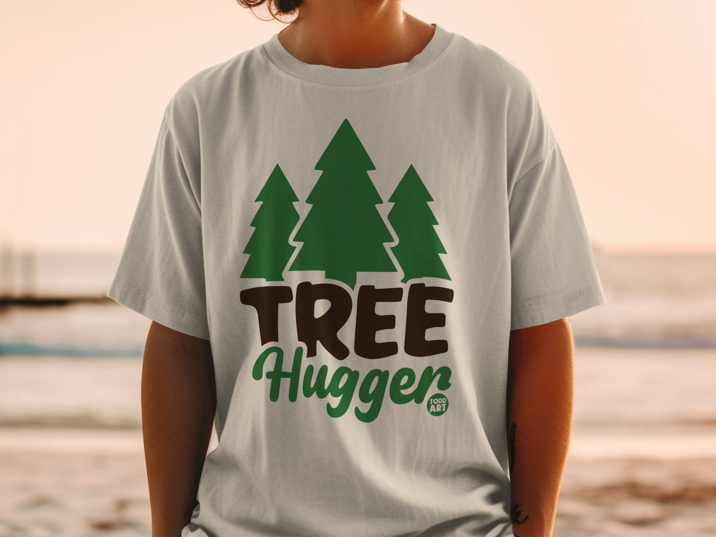 T-shirt with green pine trees and "TREE Hugger" text.